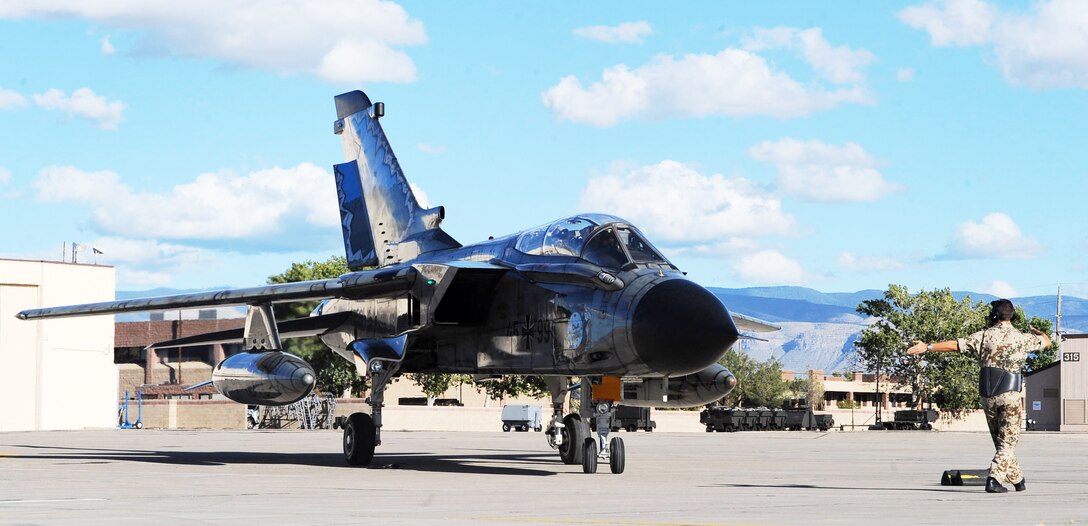 Col. Peter Klement, German air force Flying Training Center commander and Col. Jeff Harrigian, 49th Fighter Wing commander, taxi a German Tornado at Holloman Air Force Base, N.M. Oct. 13, 2009, after achieving the 55, 555 flight hour for FTC aircrews.  Members of the German air force and the 49th FW gathered for a ceremony to commemorate the achievement.  (U.S. Air Force photo/Airman 1st Class Veronica Stamps)