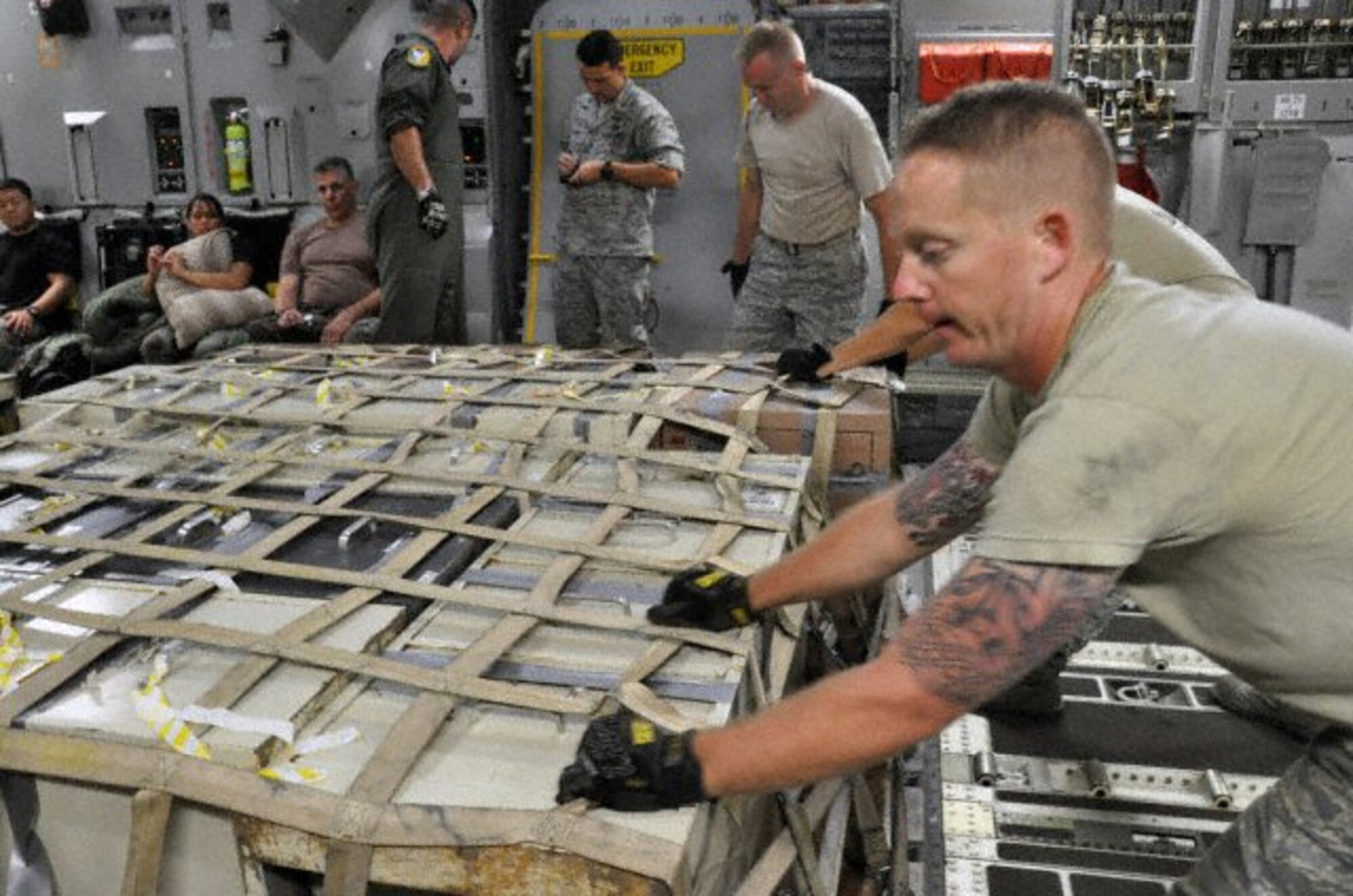 PAGO PAGO - Owensboro, Ky. native Staff Sgt. Patrick Haney of the 515th Air Mobility Squadron, Hickam AFB, Hawaii helps push a pallet into place aboard a C-17 Globmaster from March AFB, Calif. before departing Pago Pago, American Samoa on Oct. 3, 2009 where Soldiers, Sailors, Airmen and Coast Guard from the active duty, guard and reserves responded in relief efforts after an earthquake and a tsunami damaged the island and it's villages on Sept. 30, 2009. (U.S.  Air Force photo/Tech Sgt. Cohen A. Young)