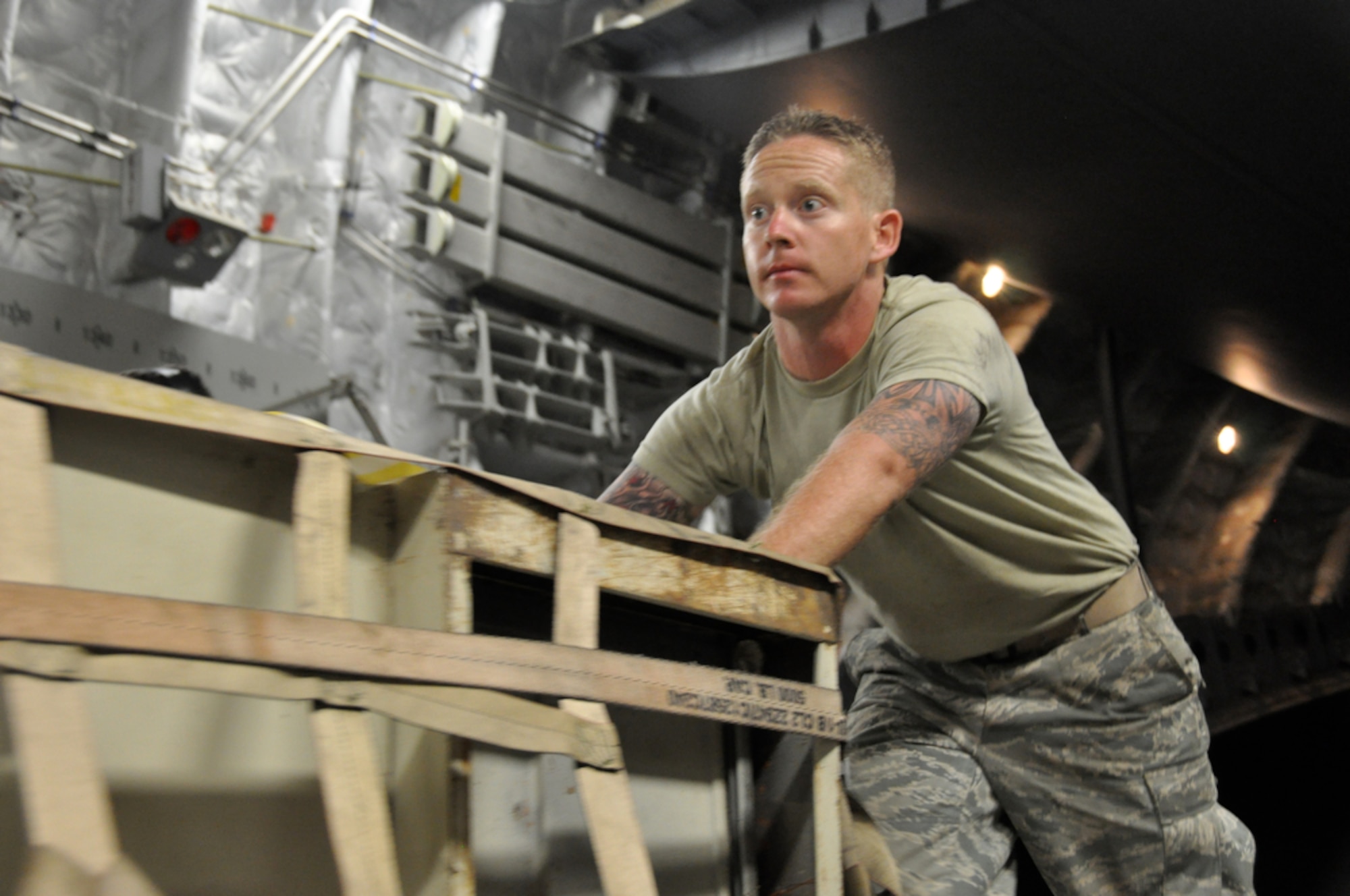 PAGO PAGO - Owensboro, Ky. native Staff Sgt. Patrick Haney of the 515th Air Mobility Squadron, Hickam AFB, Hawaii helps push a pallet into place aboard a C-17 Globmaster from March AFB, Calif. before departing Pago Pago, American Samoa on Oct. 3, 2009 where Soldiers, Sailors, Airmen and Coast Guard from the active duty, guard and reserves responded in relief efforts after an earthquake and a tsunami damaged the island and it's villages on Sept. 30, 2009. (U.S.  Air Force photo/Tech Sgt. Cohen A. Young)