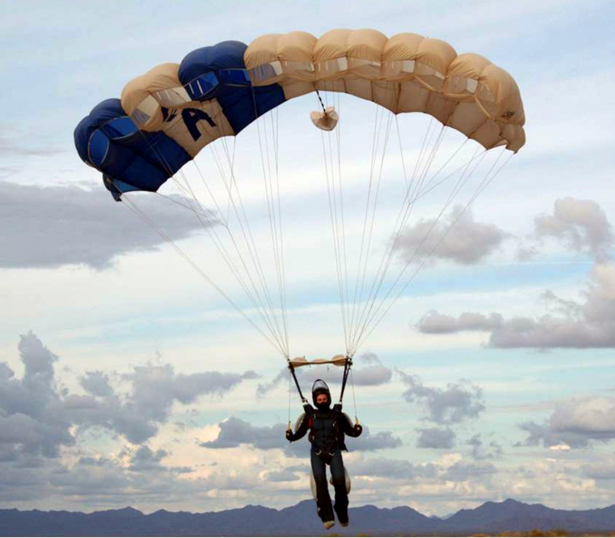Maj. Jennifer Wrynn, a Reservist, jumpmaster and instructorassigned to the U.S. Air Force Academy, decends with her Air Force canopy after one of her many jumps.  (courtesy photo)
