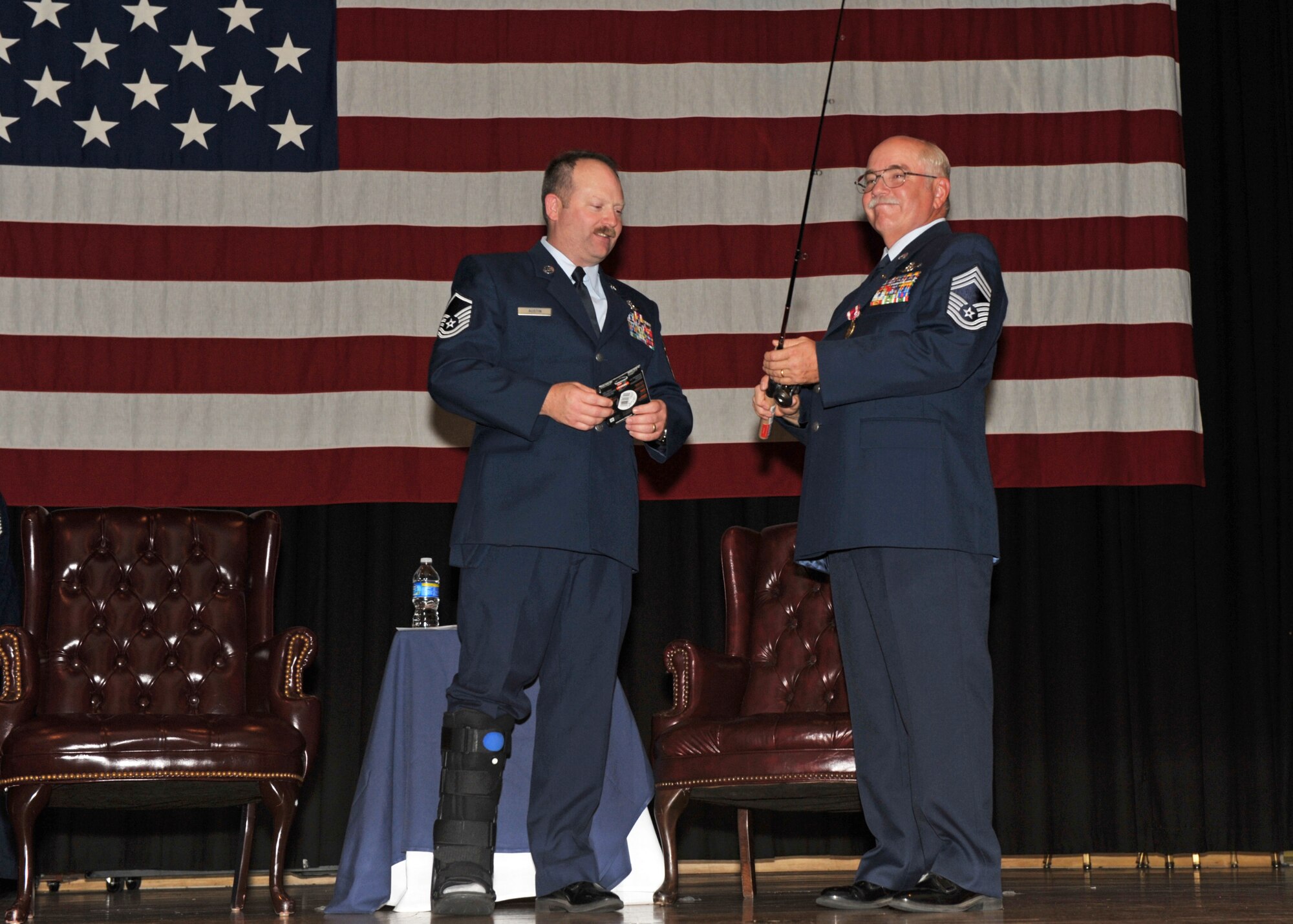 Chief Master Sgt. Don Askren holds the fishing rod presented to him by Master Sgt. John "Tex" Austin during Chief Askren's retirement ceremony at McConnell Air Force Base, Kan., on Oct. 17. The chief was a charter member of the 931st Air Refueling Group and chief boom operator of its flying unit, the 18th Air Refueling Squadron. (U.S. Air Force photo/Master Sgt. Jason Schaap)