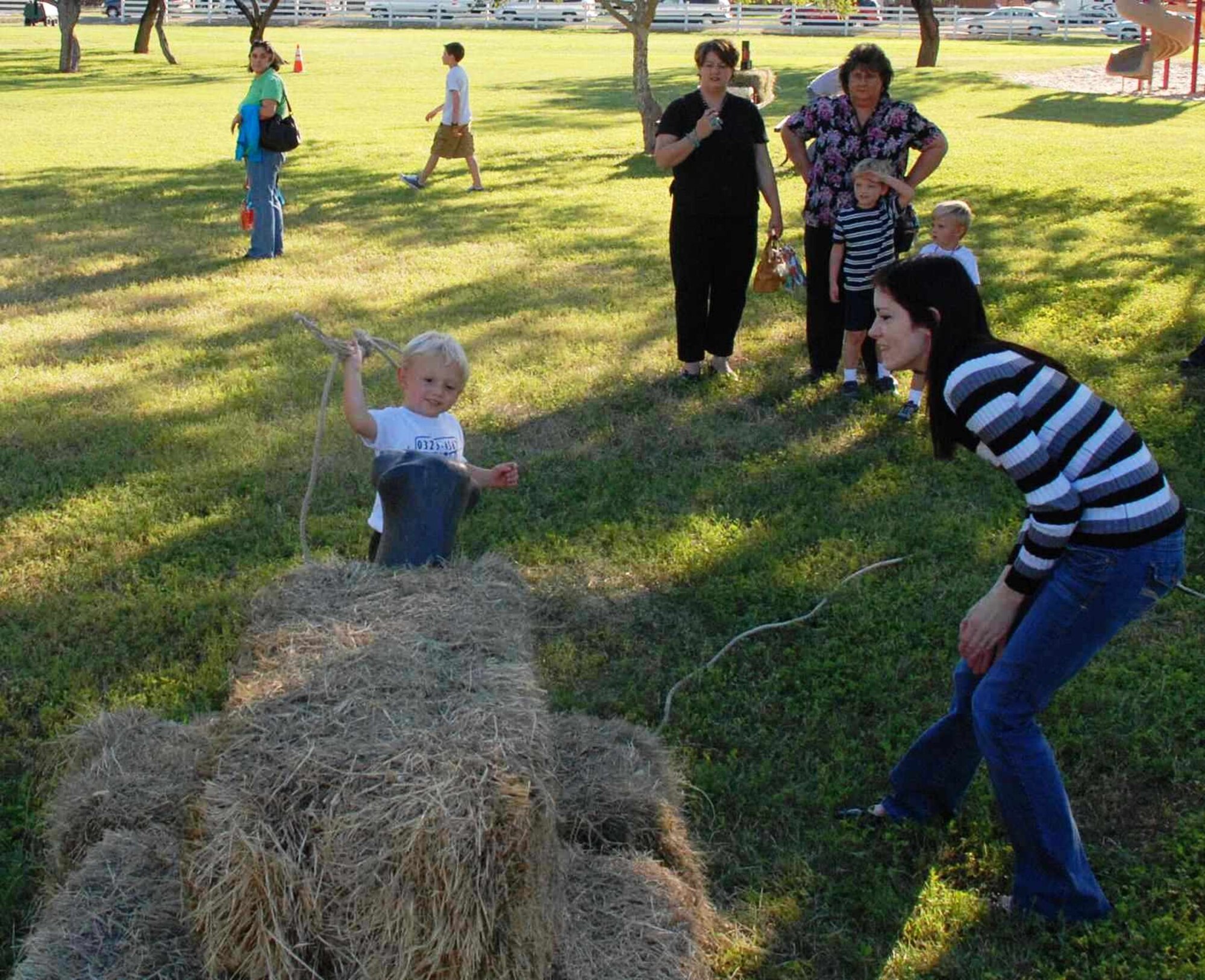 LAUGHLIN AIR FORCE BASE, Texas – Landon Sutton attempts to lasso a make-believe bull at the rope-toss event as his family and Kara Richie look on in support at the annual fall festival here Oct. 17. The festival was hosted by the Laughlin Officers’ Spouses’ Club, which uses the money raised to assist in causes that benefit the Laughlin and Del Rio communities in a number of ways, including providing scholarships for local high school seniors and military spouses. (U.S. Air Force photo by Airman 1st Class Blake Mize) 