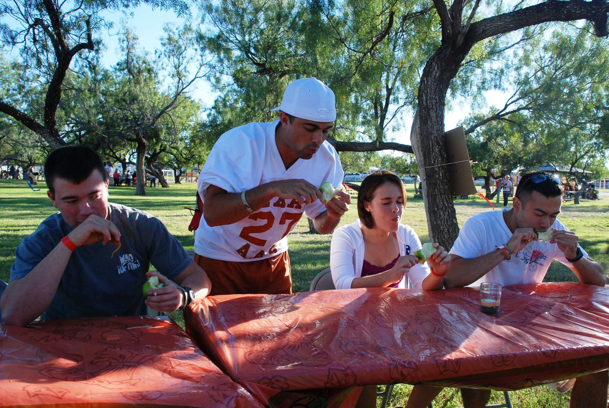 LAUGHLIN AIR FORCE BASE, Texas – Second Lieutenants Josiah Hart, Vincent Levraea, Kristen Jones and William Dana, 47th Operations Support Squadron, participate in the caramel apple-eating contest at the annual fall festival here Oct. 17. The festival was hosted by the Laughlin Officers’ Spouses’ Club, which uses the money raised to assist in causes that benefit the Laughlin and Del Rio communities in a number of ways, including providing scholarships for local high school seniors and military spouses. (U.S. Air Force photo by Airman 1st Class Blake Mize)