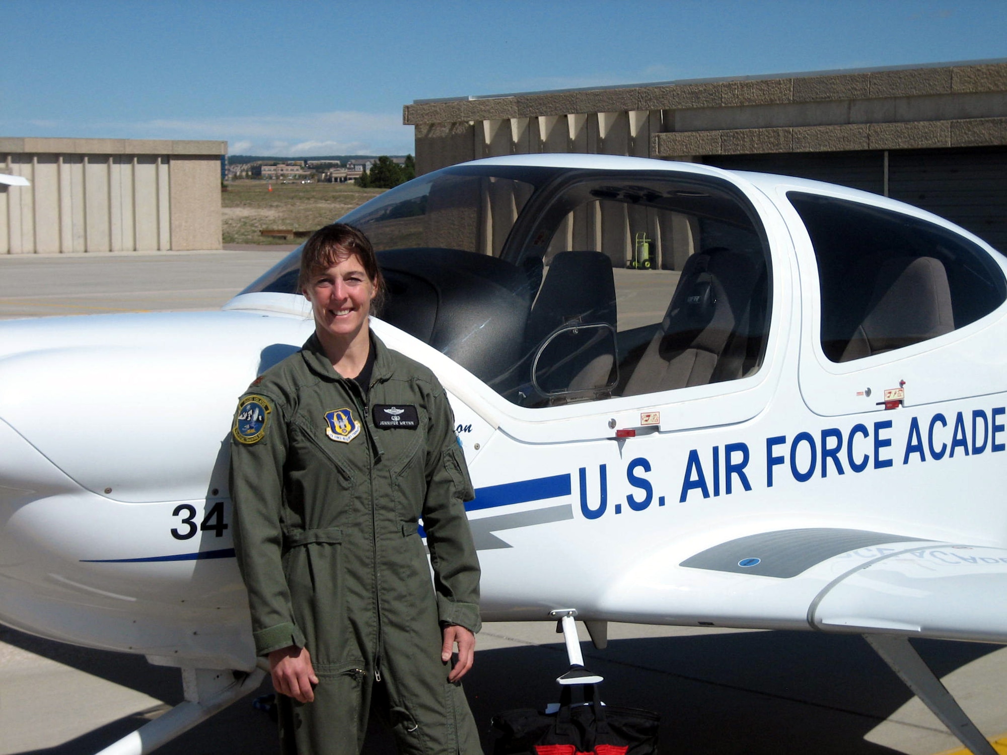 Lt. Col. (select) Jennifer Wrynn, a Reserve, U.S. Air Force Academy pilot, instructor and jumpmaster stands in front of the plane she uses for instruction. She helped set a new world record for an all-female skydive formation at Perris Skydive, Perris, Calif., Sept. 27, with 180 other women during Jump for the Cause 2009.  (Courtesy photo)
