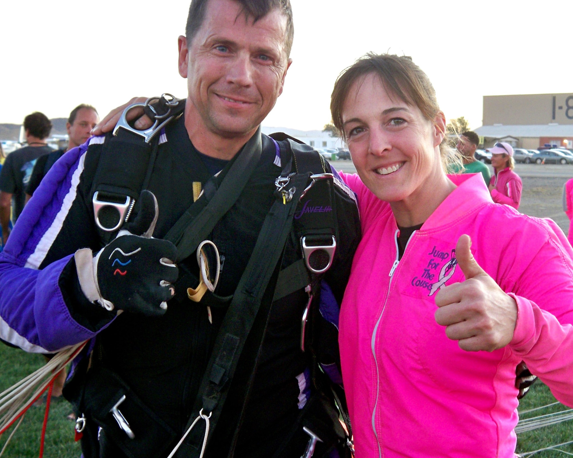 Dana Bowman, former Special Forces soldier, former member of the U.S. Army's elite parachute team, The Golden Knights and a Wounded Warrior and Lt. Col. (select) Jennifer Wrynn, U.S. Air Force Academy instructor, jumpmaster and pilot, give a 'thumbs up' in the drop zone at Skydive Perris, Perris, Calif., Sept. 25, 2009.  They took part in Jump for the Cause 2009, an event to raise money and awareness for breast cancer research and a cure.  (U.S. Air Force photo/Master Sgt. Linda E. Welz)