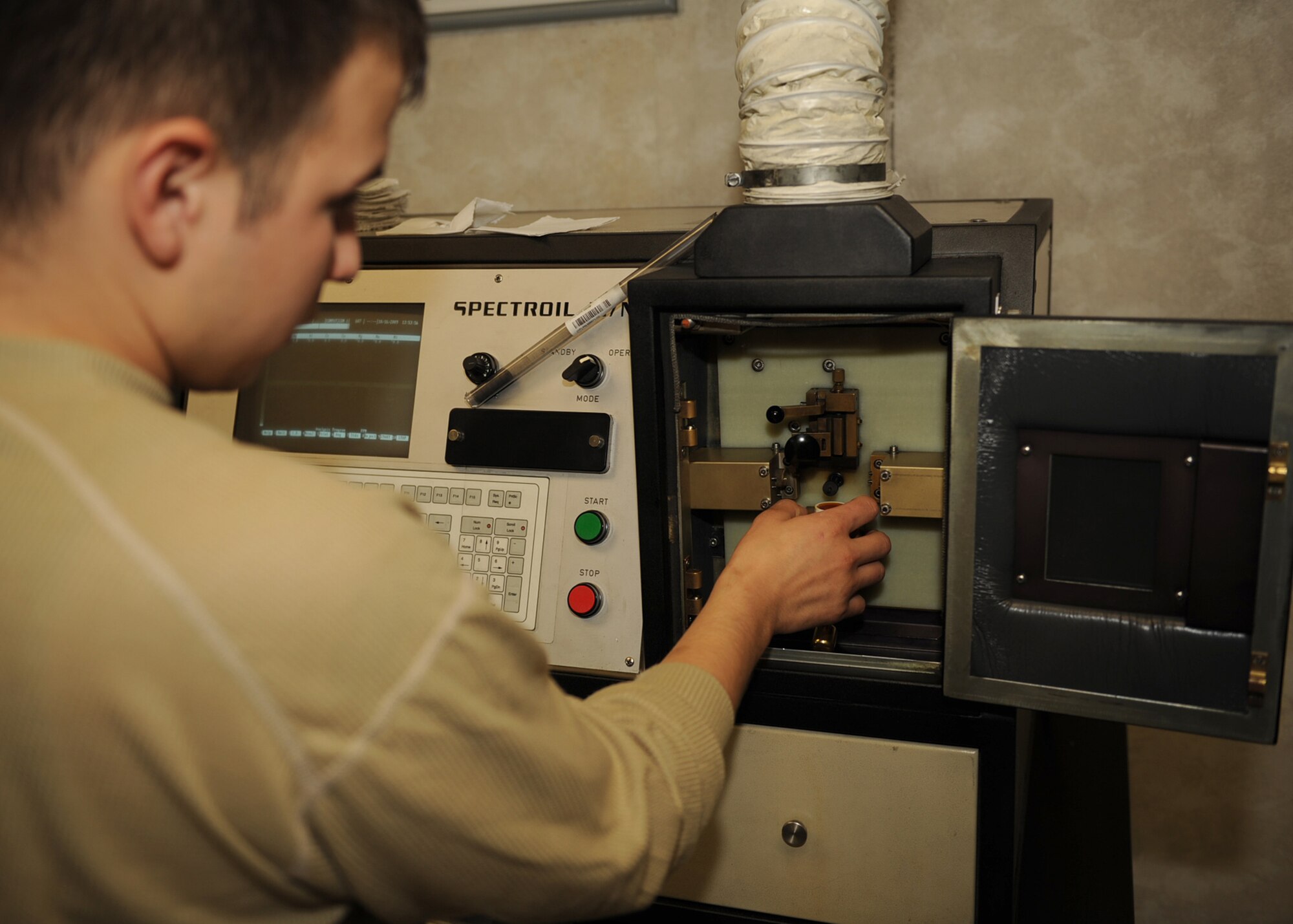 Airman Joshua Martinez, 4th Equipment Maintenance Squadron non-destructive inspector, samples oil from an F-15E Strike Eagle for wear metals on Seymour Johnson Air Force Base, N.C., Oct. 16, 2009. If a part is cracked in the engine, particles of metal can break off in the oil and causing parts to malfunction. (U.S. Air Force photo/Senior Airman Ciara Wymbs)