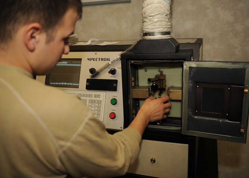 Airman Joshua Martinez, 4th Equipment Maintenance Squadron non-destructive inspector, samples oil from an F-15E Strike Eagle for wear metals on Seymour Johnson Air Force Base, N.C., Oct. 16, 2009. If a part is cracked in the engine, particles of metal can break off in the oil and causing parts to malfunction. (U.S. Air Force photo/Senior Airman Ciara Wymbs)