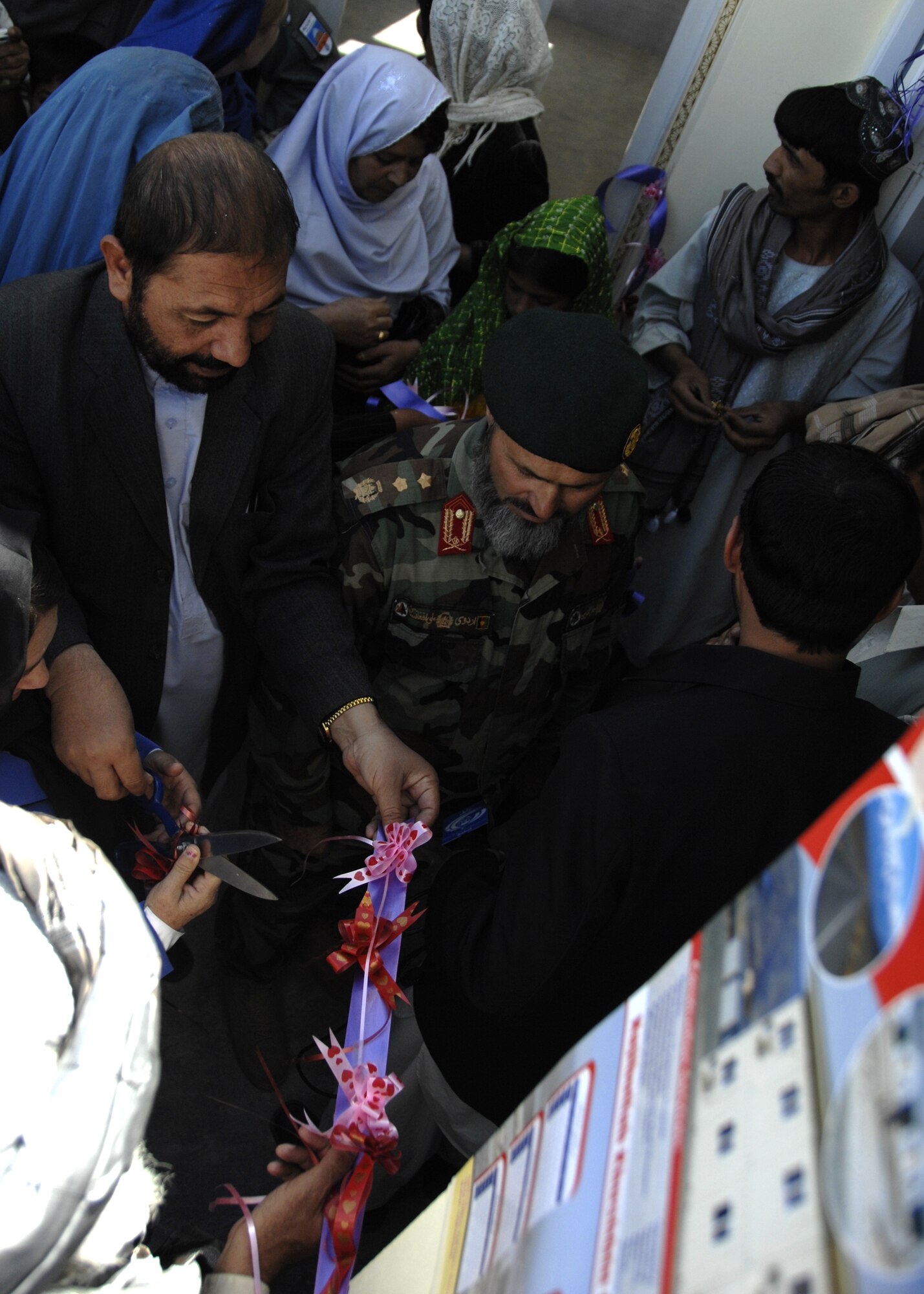 ZABUL PROVINCE, Afghanistan -- Afghan men and women celebrate the opening of the Bibi Khala Girls' School Oct. 19 in Qalat city of the Zabul Province in Afghanistan.  The Zabul Provincial Reconstruction Team played a key role in this accomplishment by providing the necessary funds.  (U.S. Air Force photo/Senior Airman Timothy Taylor)