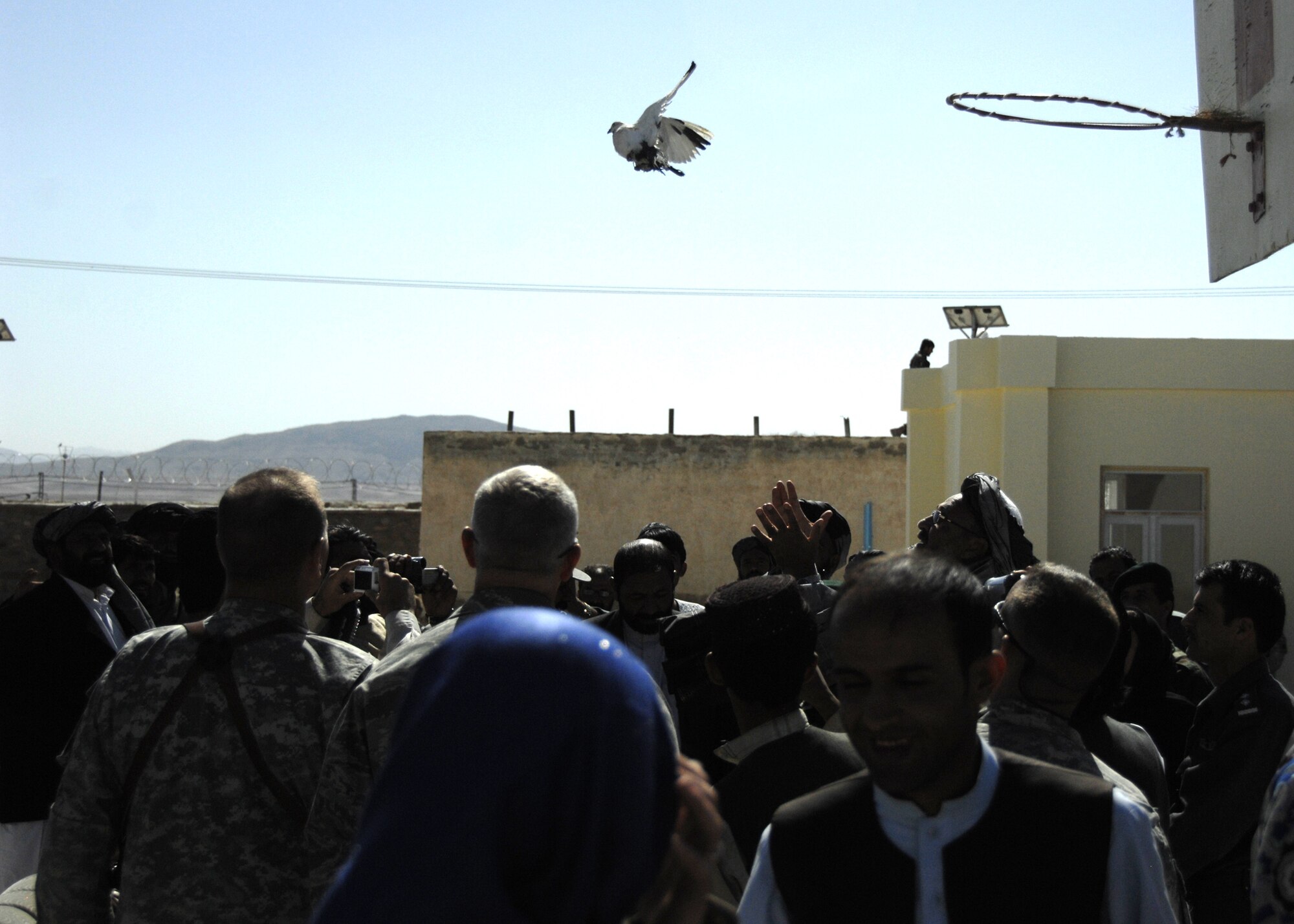 ZABUL PROVINCE, Afghanistan -- Zabul Province Governor Alhaj Ashraf Naseri
releases two doves, which symbolized a new beginning, at the conclusion of the school opening ceremony in Zabul Province, Afghanistan, Oct. 19, 2009. Ching Eikenberry, wife of Ambassador Karl Eikenberry, who initiated the idea of the new school, was also present to commemorate the opening of the all women's school. Funded by the Zabul Provincial Reconstruction Team, the construction of an additional school house with eight classrooms will allow more than 400 students of the primary school to attend classes in buildings instead of tents. (U.S. Air Force photo/Senior Airman Timothy Taylor)
