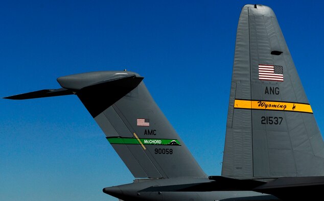 A C-17 Globemaster III aircraft from McChord Air Force Base, Wash., parks next to a Wyoming Air National Guard C-130 at the Wyoming National Guard's Guernsey Army Airfield at Camp Guernsey in Guernsey, Wyo., during the official opening of an updated airstrip capable of handling the massive cargo aircraft. The airstrip is now capable of supporting up to 20 fixed-wing aircraft as well as three C-17's. In addition to the civilian/military air strip, Camp Guernsey also boasts nearly 70,000 acres of terrain and supports approximately 65 square miles of restricted air space up to 30,000 feet. (Photo by Brandon Quester/Public Affairs Specialist/Wyoming National Guard)