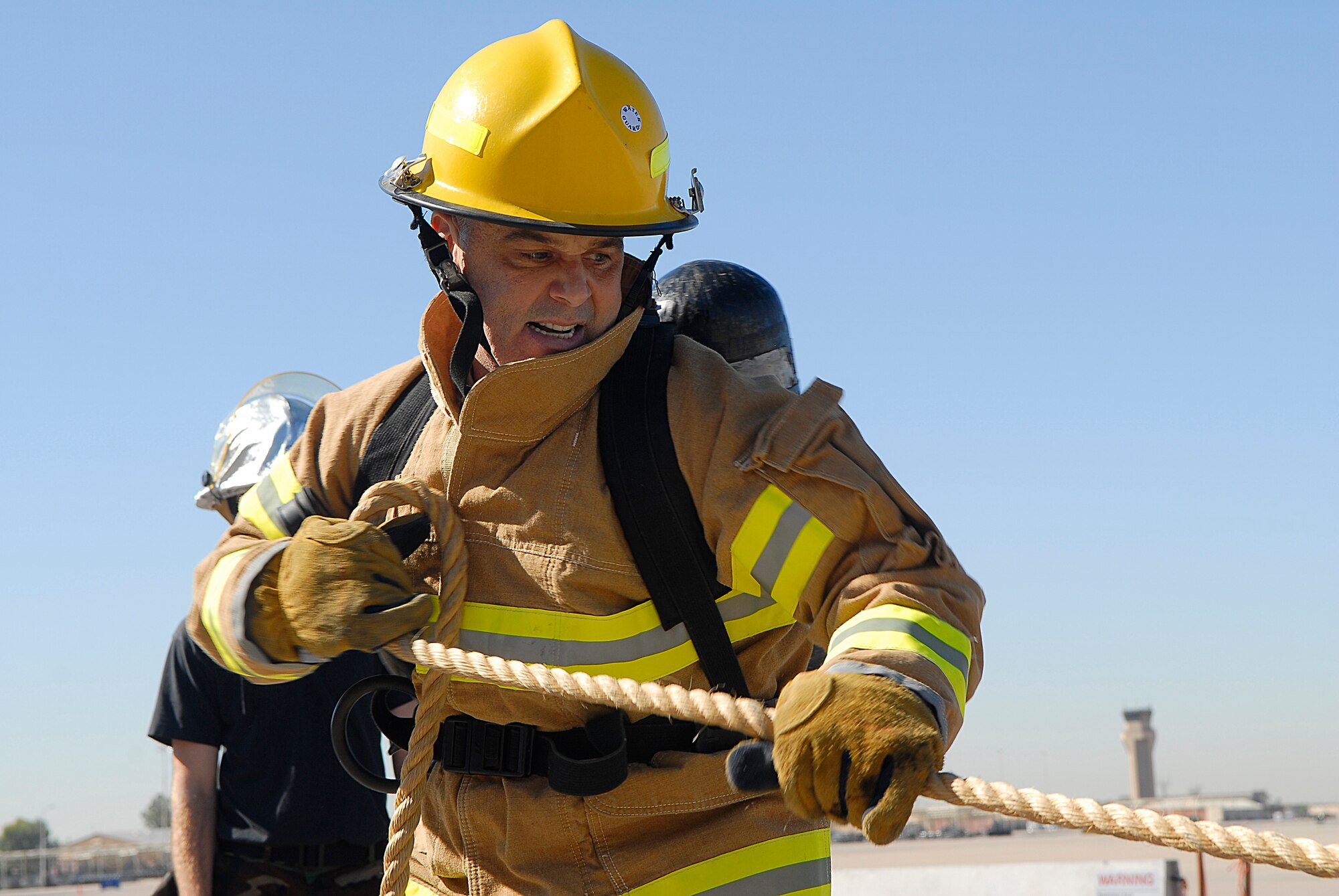 Col. Jeffrey Weed, 56th Fighter Wing vice commander, pulls a rope attached to a  weighted pallet to the end position during the Firefighter Combat Challenge held at the Fire Station Oct. 16. Col. Weed competed in the challenge twice that day.  (U.S. Air Force photo by Airman 1st Class Ronifel Yasay)