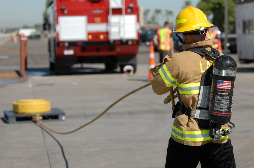 Airman 1st Class Robert Smoot, 56th Communications Squadron, pulls a weighted pallet to the finish box during the Firefighter Combat Challenge held at the Luke Air Force Base Fire Station, October 16, 2009. (U.S. Air Force photo by Airman 1st Class Sandra Welch) 