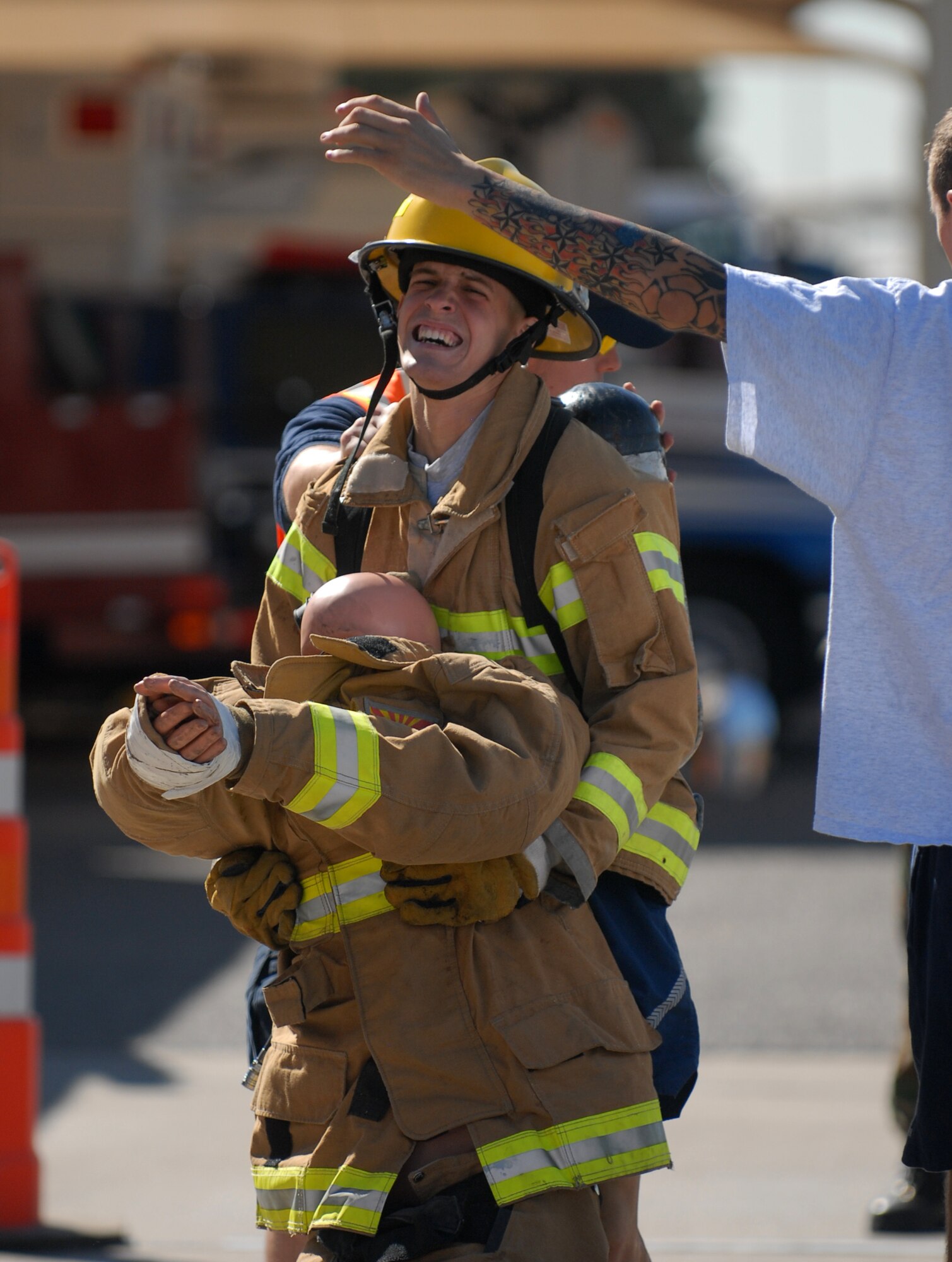Airman 1st Class Keegan Connelly, 56th Security Forces Squadron, carries the 135 lb. dummy across the finish line during the Firefighter Combat Challenge at the Luke Air Force Base Fire Station, October 16, 2009. (U.S. Air Force photo by Airman 1st Class Sandra Welch) 