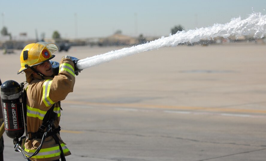 Airman 1st Class Daniel Poveda, 56th Medical Group, sprays the target with a charged fire hose during the Firefighter Combat Challenge held at the Luke Air Force Base Fire Station, October 16, 2009. (U.S. Air Force photo by Airman 1st Class Sandra Welch)  
