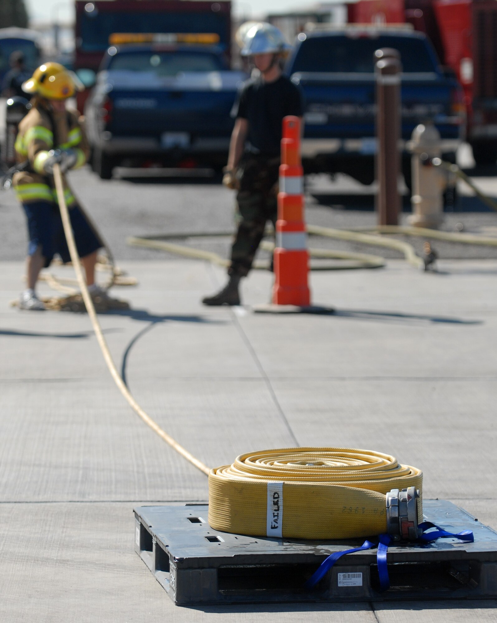 Airman 1st Class Daniel Poveda, 56th Medical Group, pulls a weighted pallet to the finish box during the Firefighter Combat Challenge held at the Luke Air Force Base Fire Station, October 16, 2009. (U.S. Air Force photo by Airman 1st Class Sandra Welch) 