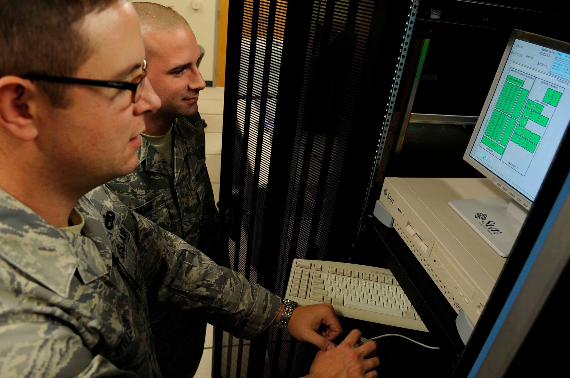 ELLSWORTH AIR FORCE BASE, S.D.--(Left) Tech. Sgt. Jason Willson, 28th Communications Squadron radar maintenance NCO in-charge and Airman 1st Class Gary Isabelle, 28th Communications Squadron radar maintenance technician, view the status of the Digital Airport Surveillance Radar, Oct. 14. The DASR technology is the newest available technology and it uses less power, requires less maintenance and manpower, and costs significantly less to operate than other systems currently in use. (U.S. Air Force photo/Airman 1st Class Corey Hook)
