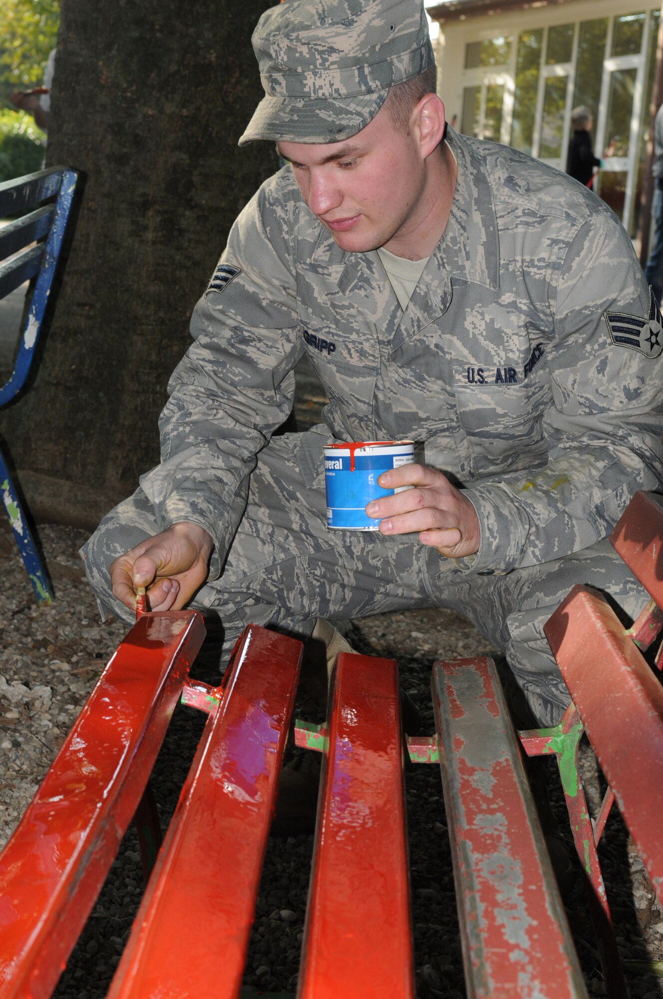 Senior Airman Zachary Gripp, 603rd Air Control Squadron vehicle maintainer, paints a bench in the school yard of an elementary school Oct. 16, 2009 in San Quirino, Italy. Members of the 603rd ACS dedicated 60 hours of their time assisting the school with various beautification projects to include painting playground equipment, cutting the grass and handing out donated school supplies. (U.S. Air Force photo/ Senior Airman Nadine Y. Barclay)
