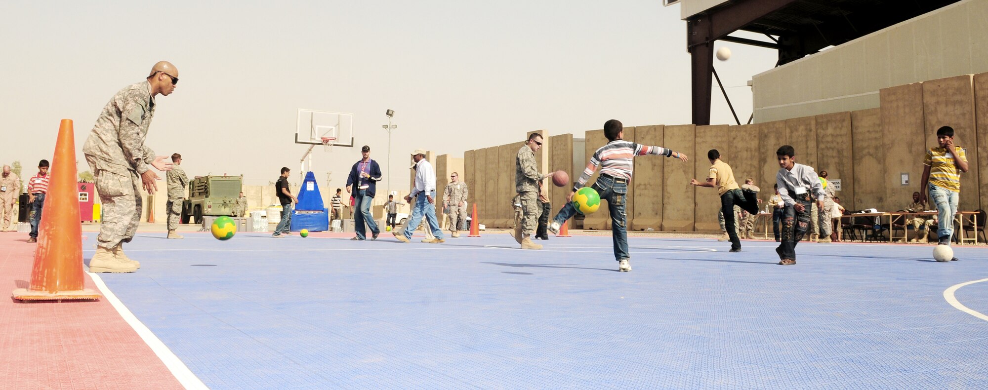 Servicemembers play sports with local children during Iraqi Children's Day Oct. 10, 2009, at Joint Base Balad, Iraq. (U.S. Air Force photo/Staff Sgt. Heather M. Norris) 
