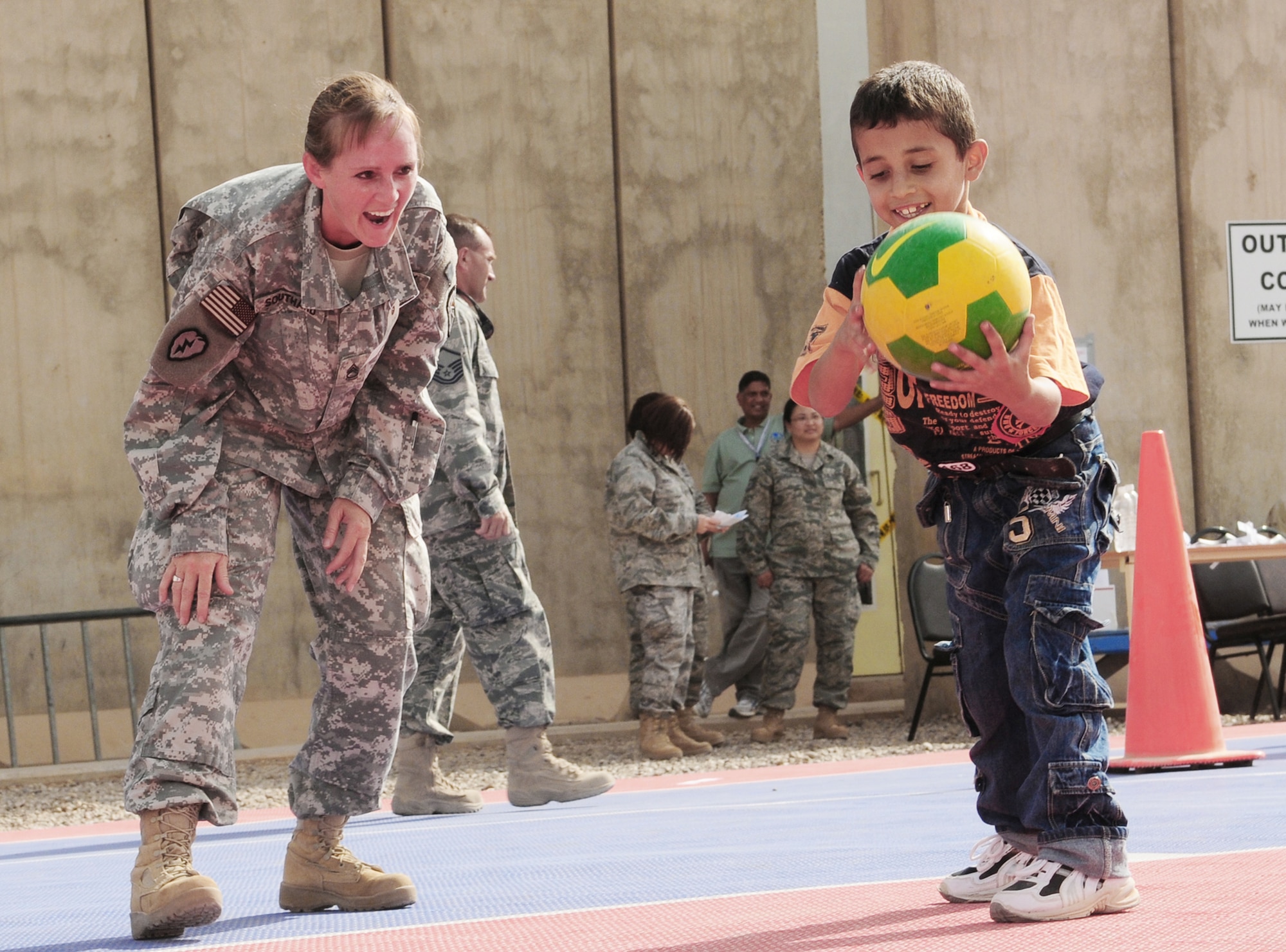 Army Sgt. 1st Class Diana Southard plays basketball with an Iraqi child Oct. 10, 2009, at Joint Base Balad, Iraq. Sergeant Southard is the 23rd Ordnance Headquarters platoon sergeant. (U.S. Air Force photo/Staff Sgt. Heather M. Norris) 
