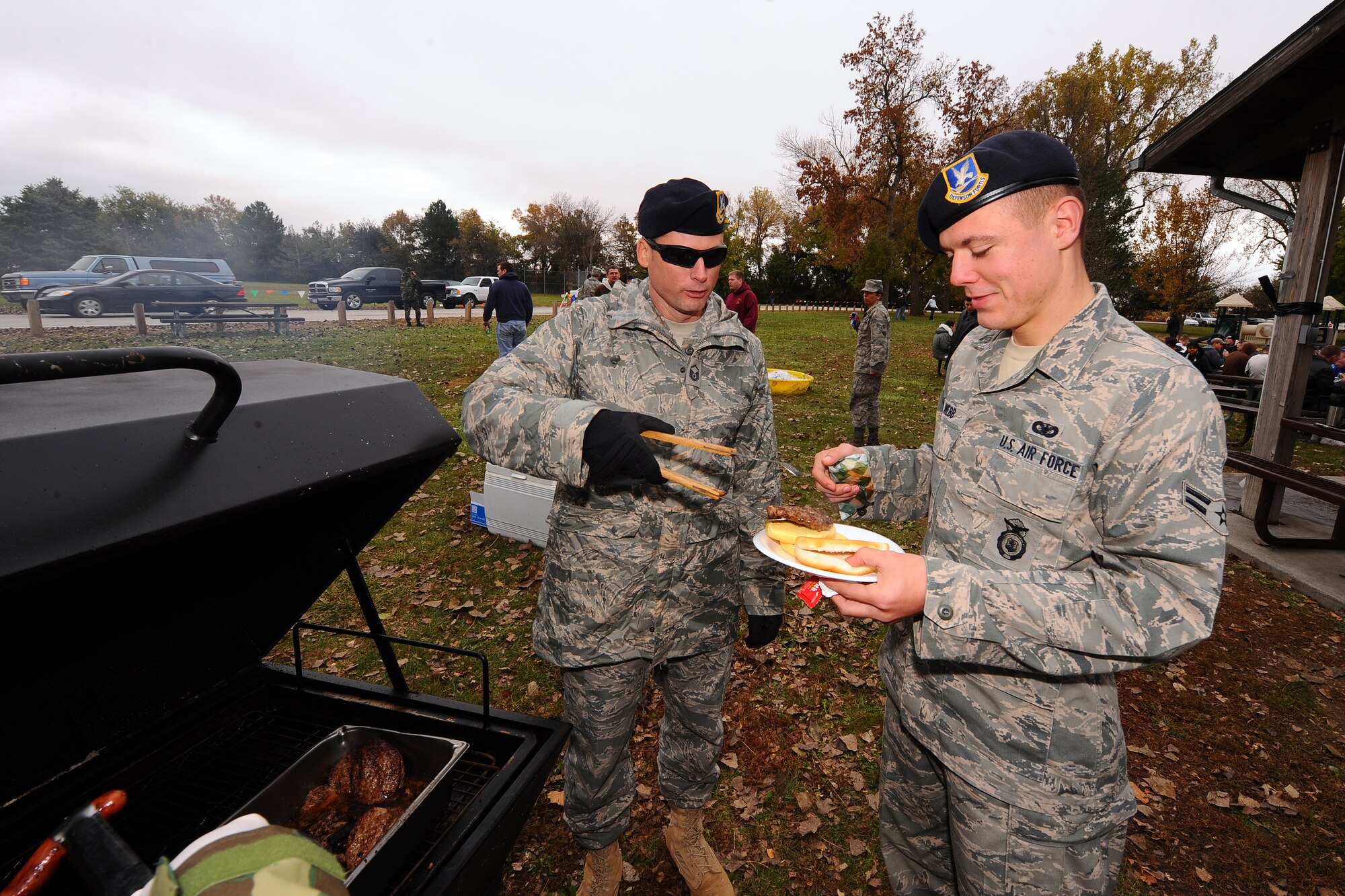 OFFUTT AIR FORCE BASE, Neb. - Master Sgt. Justin King, 55th Security Forces Squadron, serves a hamburger hot off the grill to Airman 1st Class Zach Webb, 55th SFS, as part of Airman Appreciation Day at the base lake Oct. 16.  The event featured hamburgers, hotdogs, roasted marshmallows and a comedy showcase which included three comedians.

U.S. Air Force Photo by Josh Plueger 
