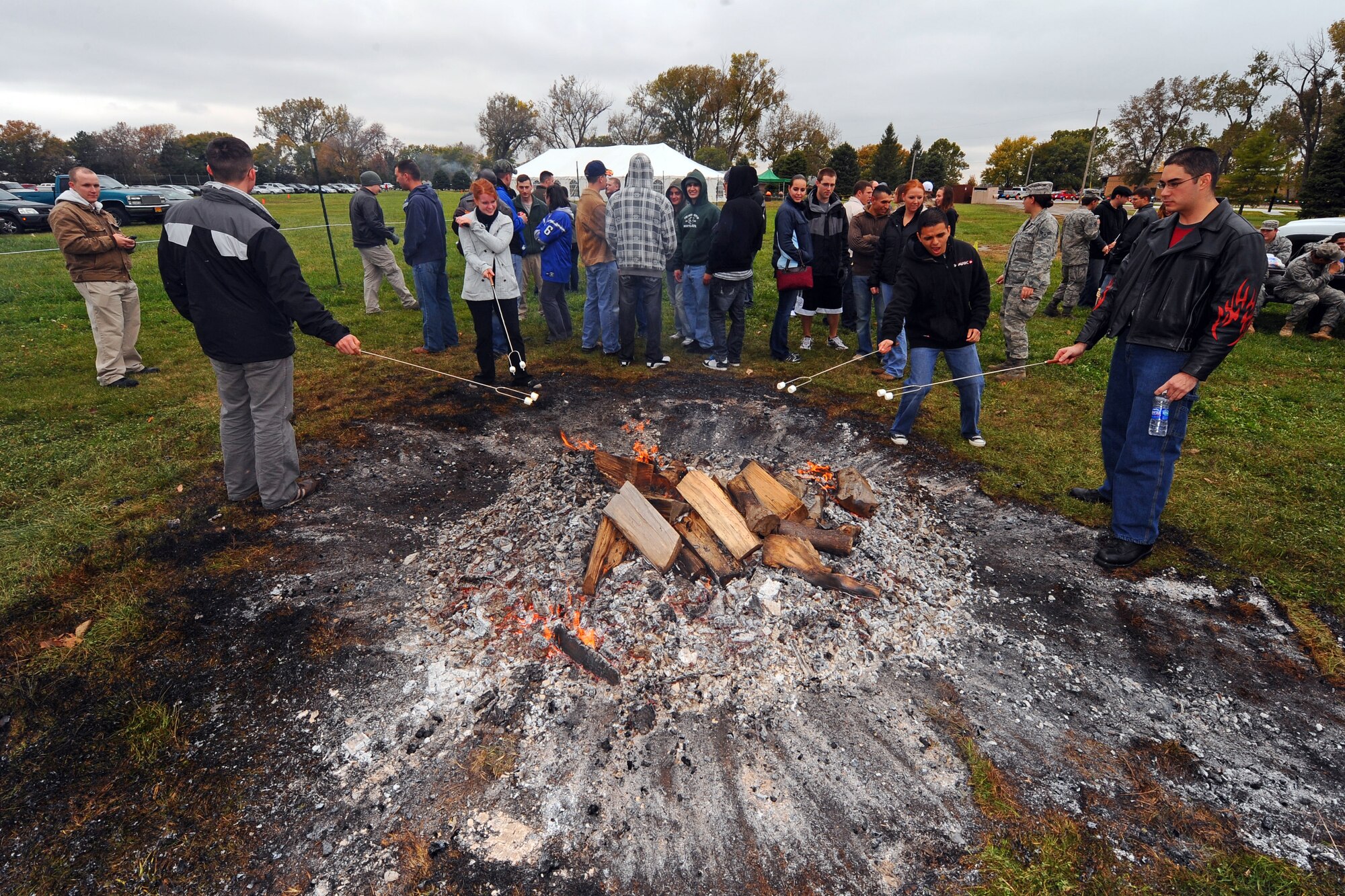 OFFUTT AIR FORCE BASE, Neb. - 55th Wing Airmen stand close to the fire roasting marshmallows during a cold afternoon at the base lake Oct. 16 as part of Airman Appreciation Day.  Following a barbecue and marshmallow roast, Offutt Airmen were treated to the talents of three comedians.

U.S. Air Force Photo by Josh Plueger