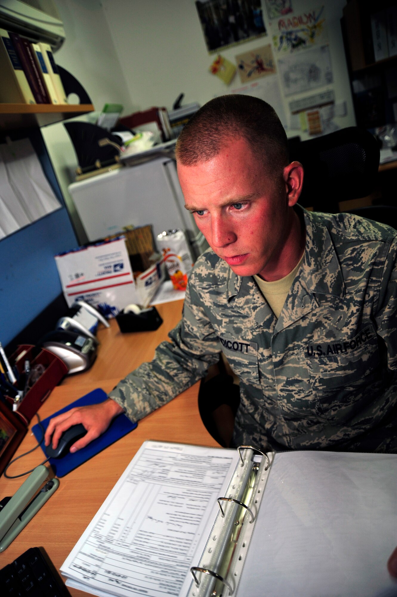 SOUTHWEST ASIA -Senior Airman Jason Endicott, 380th Expeditionary Contracting Squadron contracting officer, researches purchase requests here Oct. 20, 2009. Airman Endicott is deployed from Holloman Air Force Base, N.M., and hails from Hampstead, Md. (U.S. Air Force photo/Tech. Sgt. Charles Larkin Sr)
