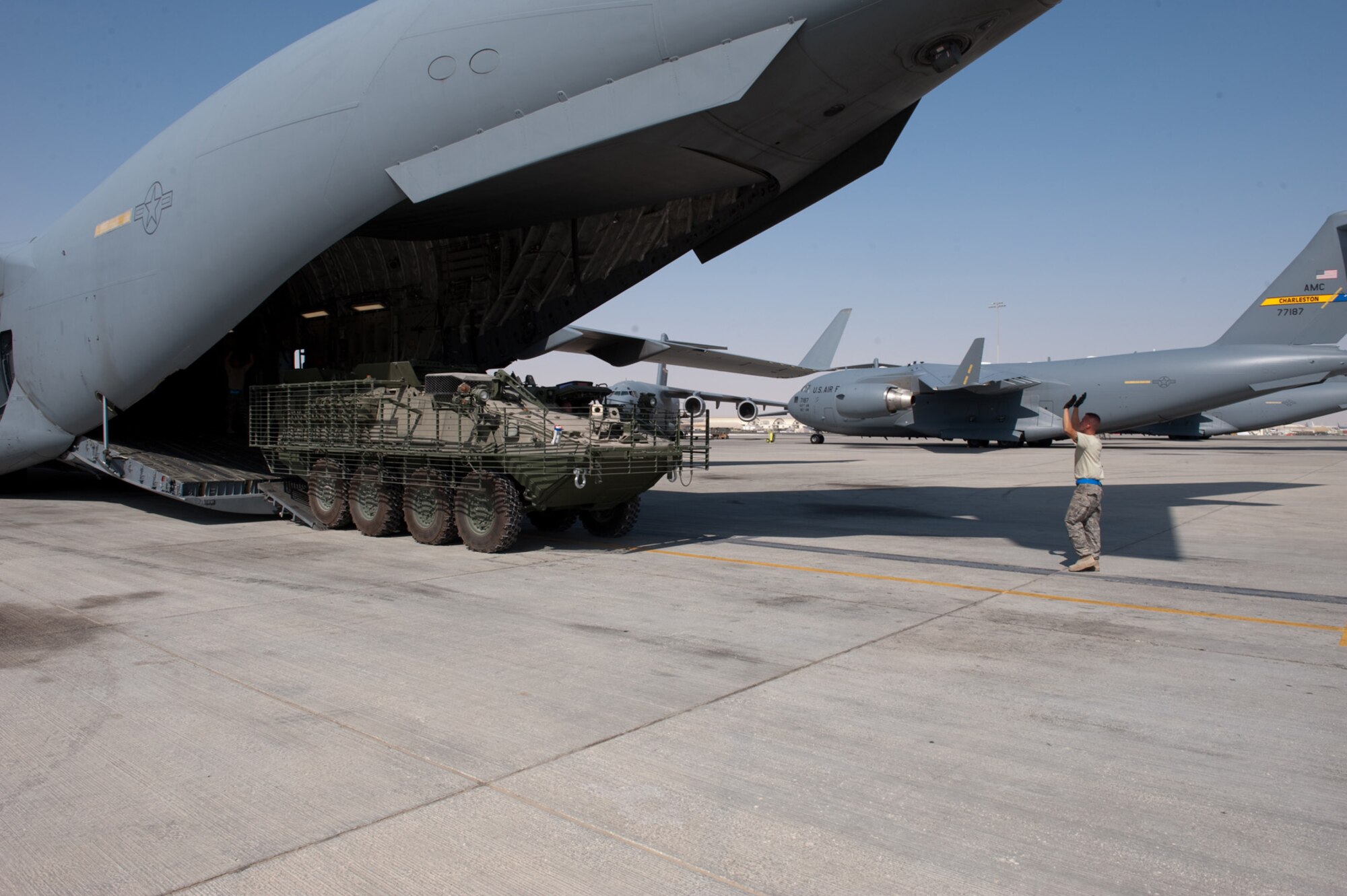 Staff Sergeant Randy Walgren, 8th Expeditionary Air Mobility Squadron, guides a Stryker M1126 Infantry Carrier Vehicle onto a C-17 Globemaster III, Oct. 17, 2009, in Southwest Asia. Sergeant Walgren, along with fellow 8 EAMS ramp section members, helps load and unload all cargo, including Stryker ICVs, for local aircraft. Sergeant Walgren is deployed from Altus Air Force Base, Okla., in support of operations Iraqi Freedom and Enduring Freedom. (U.S. Air Force photo/Staff Sgt. Robert Barney) 