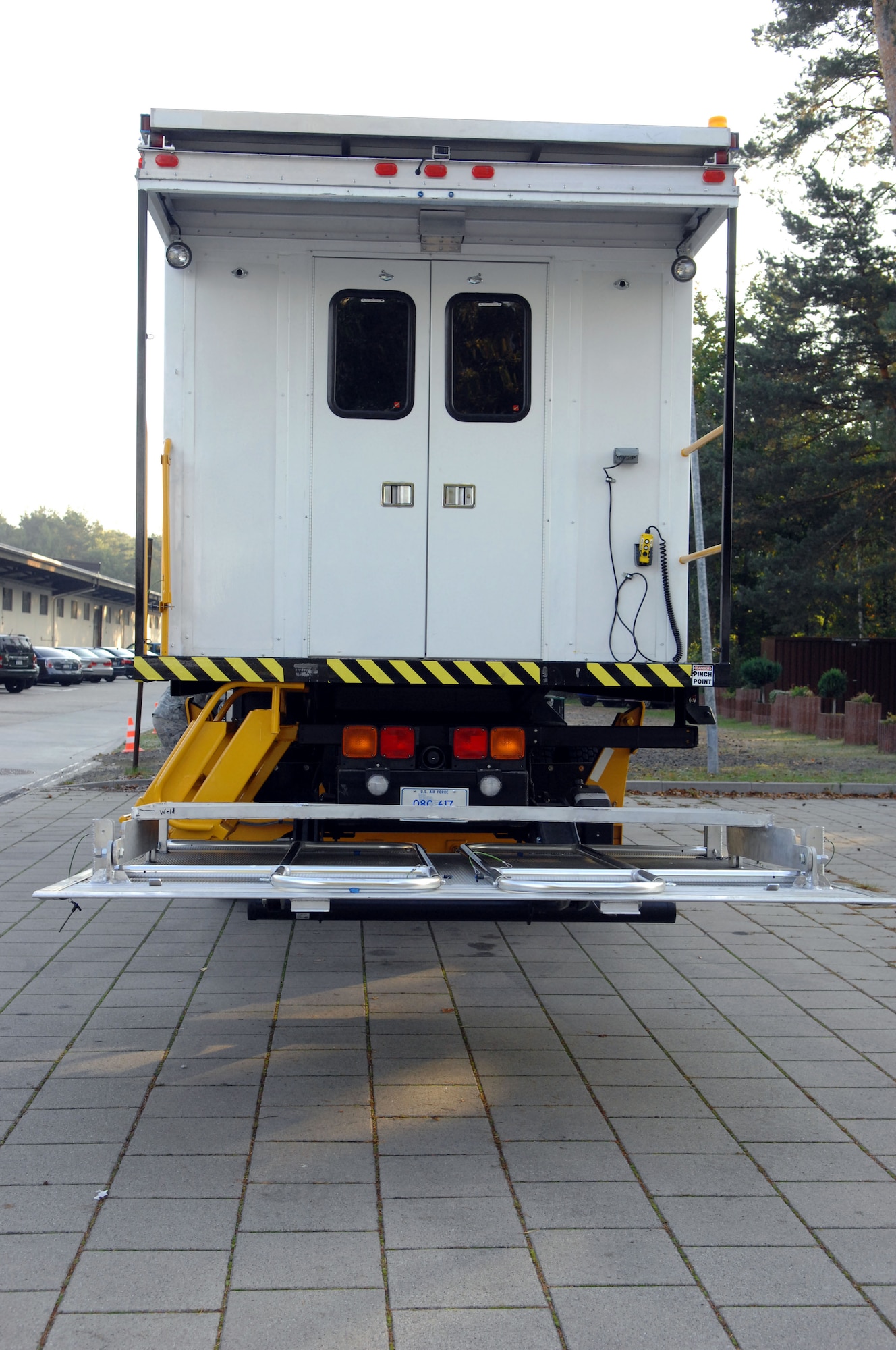 The high deck patient loading platform vehicle, or HDPLP, sits in the lowered position and helps 86th Contingency Aeromedical Staging Facility personnel unload and upload patients to and from large aircraft, as well as allowing for the transportation of patients to and from the flightline, Landstuhl Regional Medical Center and the CASF. Ramstein Air Base, Germany, is home to one generation-two HDPLP. (U.S. Air Force photo by Airman 1st Class Brittany Perry)