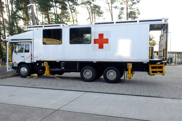 The high deck patient loading platform vehicle, or HDPLP, sits in the lowered position and helps 86th Contingency Aeromedical Staging Facility personnel unload and upload patients to and from large aircraft, as well as allowing for the transportation of patients to and from the flightline, Landstuhl Regional Medical Center and the CASF. Ramstein Air Base, Germany, is home to one generation-two HDPLP. (U.S. Air Force photo by Airman 1st Class Brittany Perry)