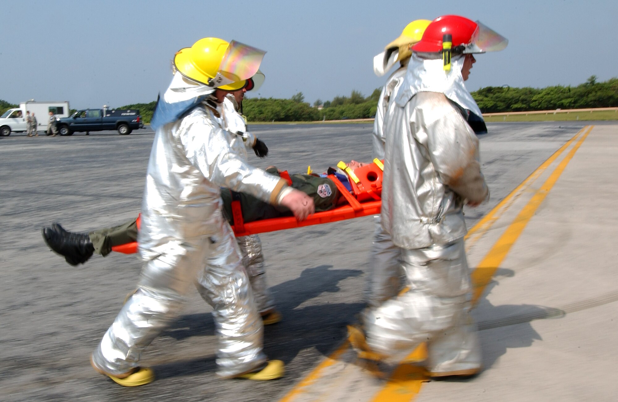 A team from the Kadena Fire Department transports an injured victim to medical personnel for treatment in a scenario involving a KC-135 Stratotanker experiencing a fire at Kadena Air Base, Japan Oct. 19 during Exercise Beverly High 10-01. The 18th Wing is participating in a Local Operational Readiness Exercise to test the readiness of Kadena Airmen Oct. 19-23. (U.S. Air Force photo/Tech. Sgt. Rey Ramon)       
                              