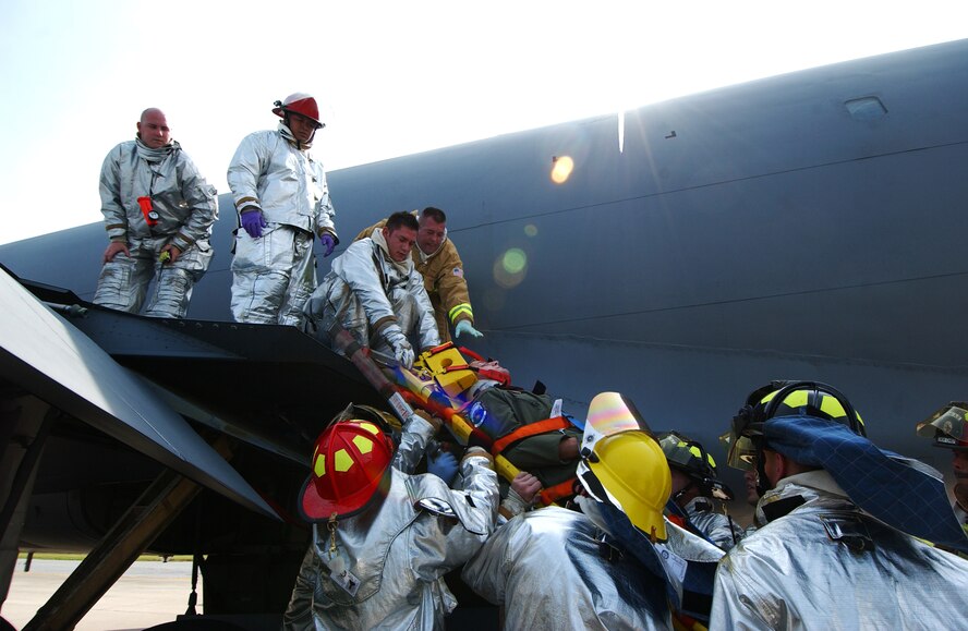 The Kadena Fire Department extracts injured victims in a scenario involving
a fire aboard a KC-135 Stratotanker at Kadena Air Base, Japan Oct. 19 during Exercise Beverly High 10-01. The 18th Wing is participating in a Local Operational Readiness Exercise to test the readiness of Kadena Airmen Oct.
19-23.  (U.S. Air Force photo/Tech. Sgt. Rey Ramon)           
                              