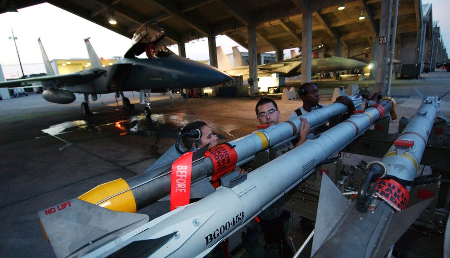 Airman 1st Class Tyler Kennemer, Staff Sgt. Joseph Radowski, and Senior Airman Johnathan Gales from the 67th Aircraft Maintenance Unit configure an Aim-9 on a weapons trailer at Kadena Air Base, Japan Oct. 19 during Exercise Beverly High 10-01. The 18th Wing is participating in a Local Operational Readiness Exercise to test the readiness of Kadena Airmen Oct. 19-23.  
(U.S. Air Force photo/Tech. Sgt. Rey Ramon)       
                                                 