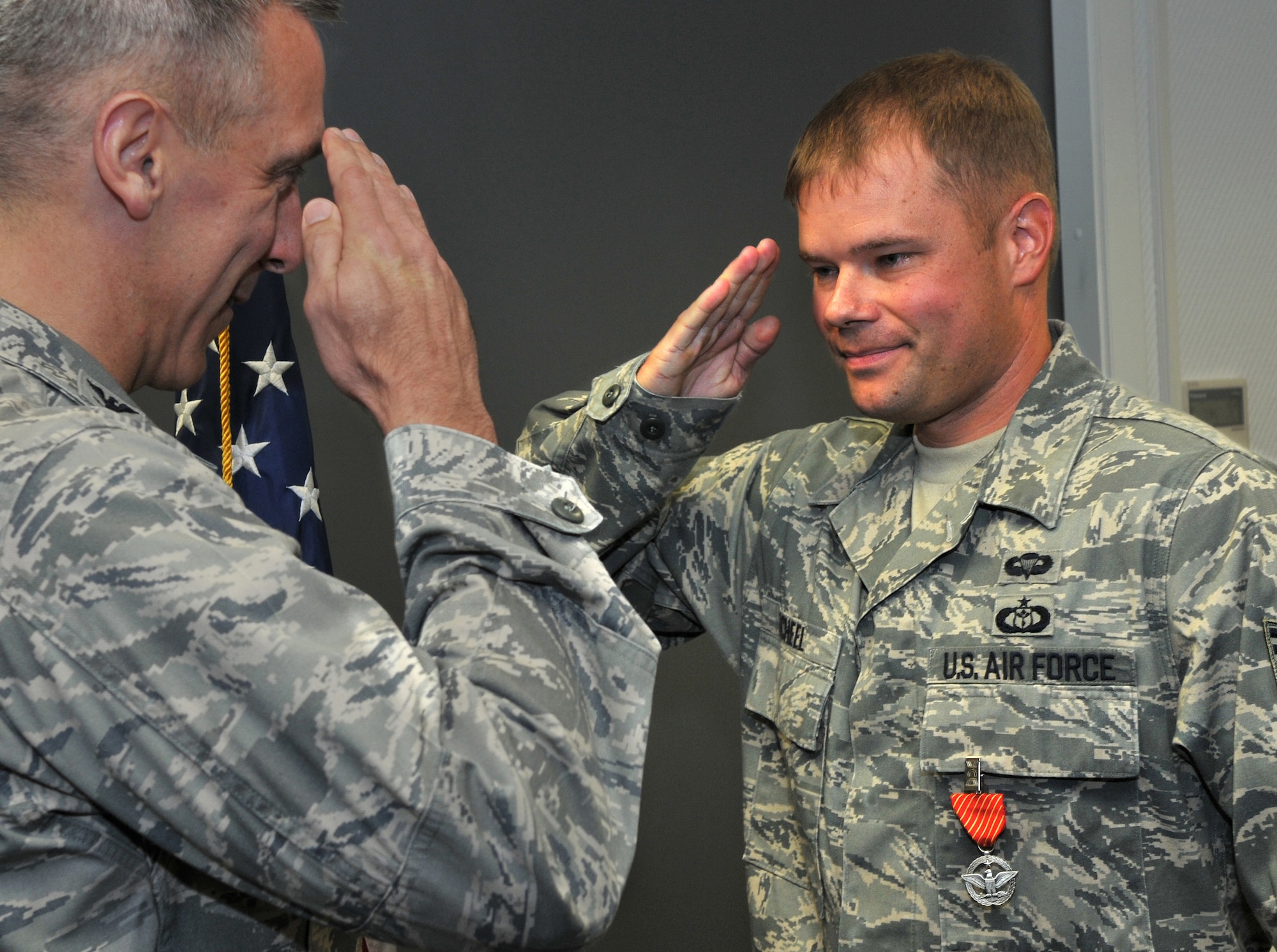 U.S. Air Force Col. Thomas F. Gould, 435th Air Ground Operations Wing commander, left, presents the Air Force Combat Action Medal to Tech. Sgt. Robert Scheel, 7th Weather Squadron battlefield weather forecaster, Oct. 14, 2009, Ramstein Air Base, Germany. Sergeant Scheel was awarded the Combat Action Medal after his ground convoy was engaged by enemy forces necessitating an immediate response of direct and lethal fire. (U.S. Air Force photo by Senior Airman Nathan Lipscomb)