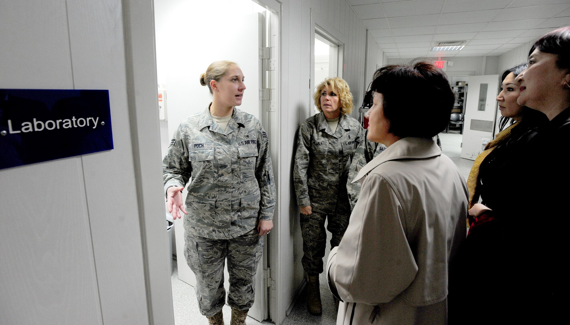 TRANSIT CENTER AT MANAS, Kyrgyzstan -- Senior Airman Amy Poch, 376th Expeditionary Medical Group laboratory technician, shows the Kyrgyz Congress of Women laboratory services during a visit at the Transit Center, Oct. 16, 2009. The Congress of Women got a full view of the medical facility and were briefed on many of the humanitarian projects the EMDG contributes to throughout Kyrgyzstan. (U.S. Air Force photo/Senior Airman Steele C. G. Britton)