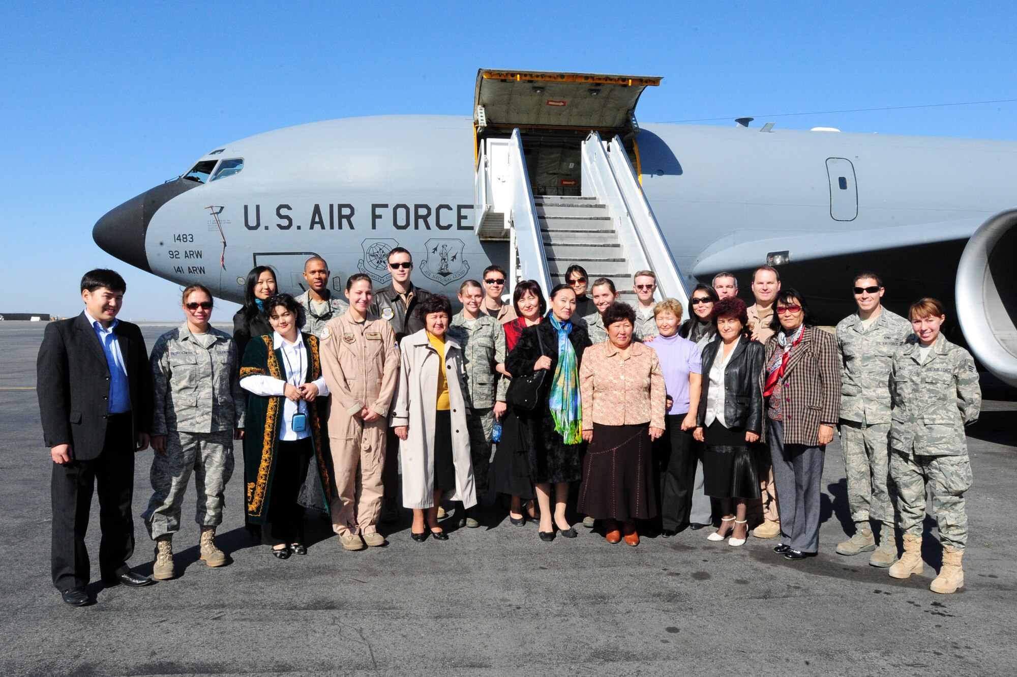 TRANSIT CENTER AT MANAS, Kyrgyzstan -- The Congress of Women of Kyrgyzstan stand with Airmen at the Transit Center during a visit, Oct. 16, 2009. The tour consisted of a visit of Manas facilities, lunch, and a full view of a KC-135 Stratotanker. (U.S. Air Force photo/Senior Airman Steele C. G. Britton)