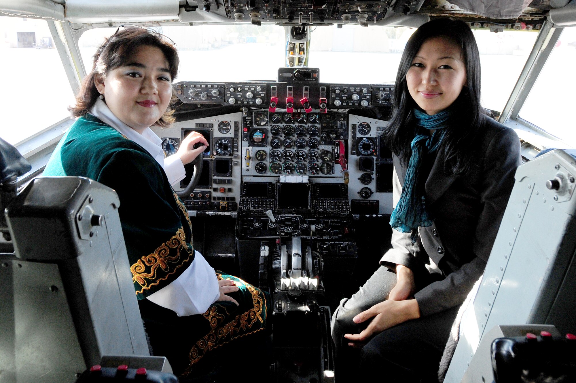 TRANSIT CENTER AT MANAS, Kyrgyzstan -- Congress of Women of Aisuluu Suerkulova, Congress of Women of Kyrgyzstan head of administration, and Aijan Musuralieva, Public Chamber of Kyrgyz Republic legal expert, take a seat in a KC-135 Stratotanker during a tour of the Transit Center, Oct. 15, 2009. (U.S. Air Force photo/Senior Airman Steele C. G. Britton)