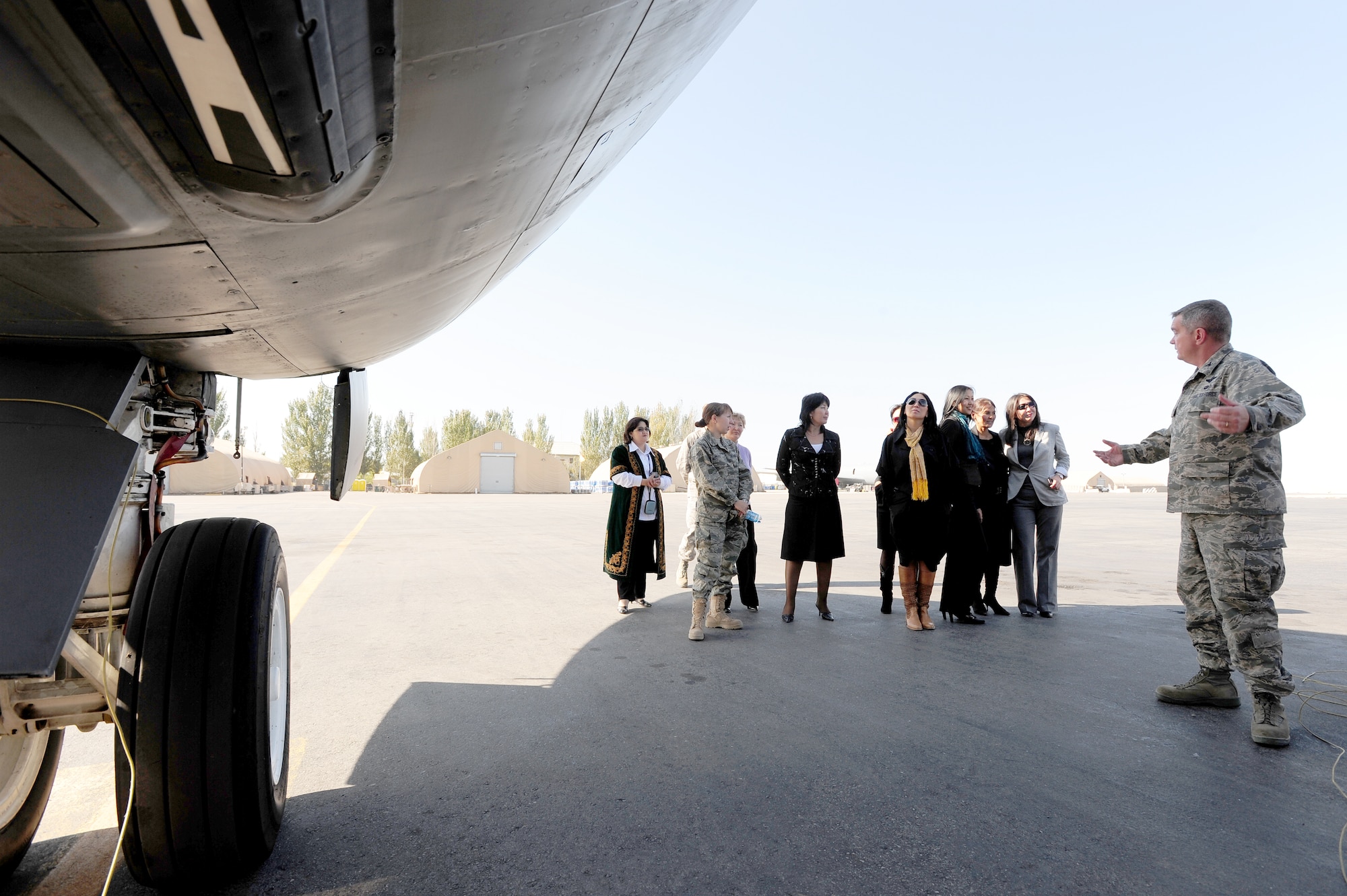 TRANSIT CENTER AT MANAS, Kyrgyzstan -- Col. Michael Mahon, 376th Air Expeditionary Wing vice commander, tours the Congress of Women of Kyrgyzstan around a KC-135 Stratotanker during a visit to the Transit Center, Oct. 16, 2009. (U.S. Air Force photo/Senior Airman Steele C. G. Britton)