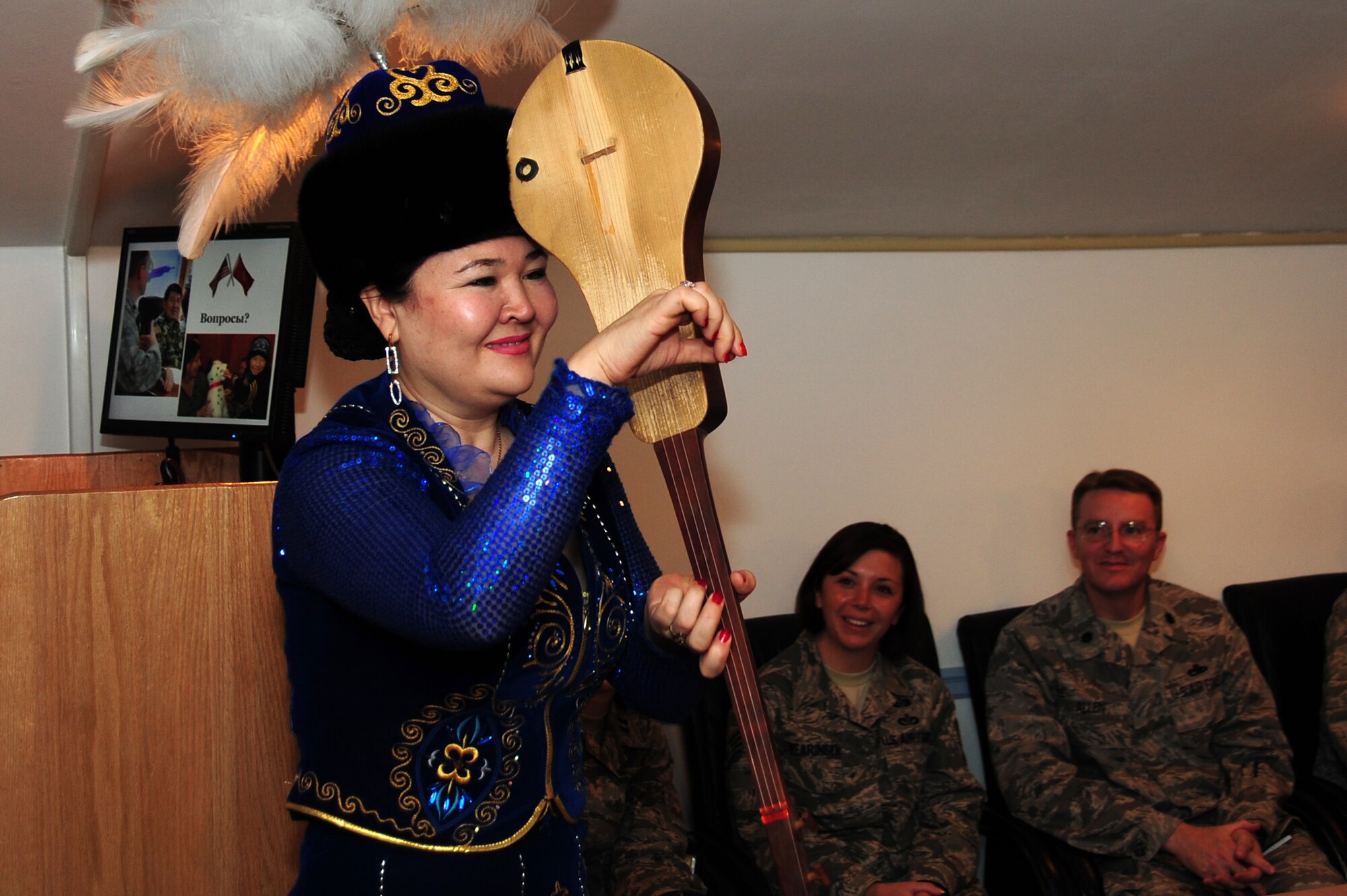 TRANSIT CENTER AT MANAS, Kyrgyzstan -- Ms. Dilshat Kangeldieva, Kyrgyz National Philharmonic singer, performs songs on the komuz for an audience of Airmen and Kyrgyz Women of Congress during a visit to the Transit Center, Oct. 16, 2009. (U.S. Air Force photo/Senior Airman Steele C. G. Britton)