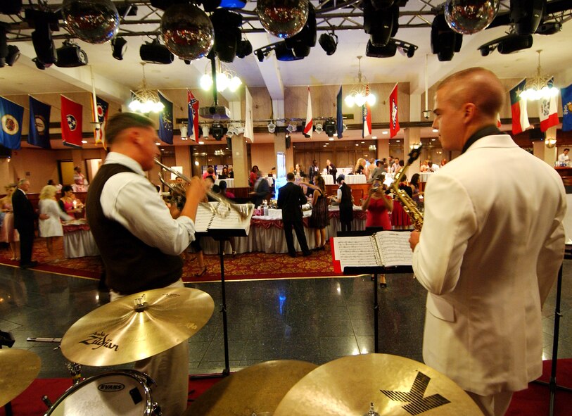 Military members and their families enjoy dinner and music 
during the Pink Dress, Purple Tie Gala at the Rocker NCO Club Oct. 17. The
event honored victims and celebrated survivors of breast cancer and domestic
violence, as well as recognized exceptional victim advocates and care
providers.  (U.S. Air Force photo/Tech. Sgt. Rey Ramon)      
