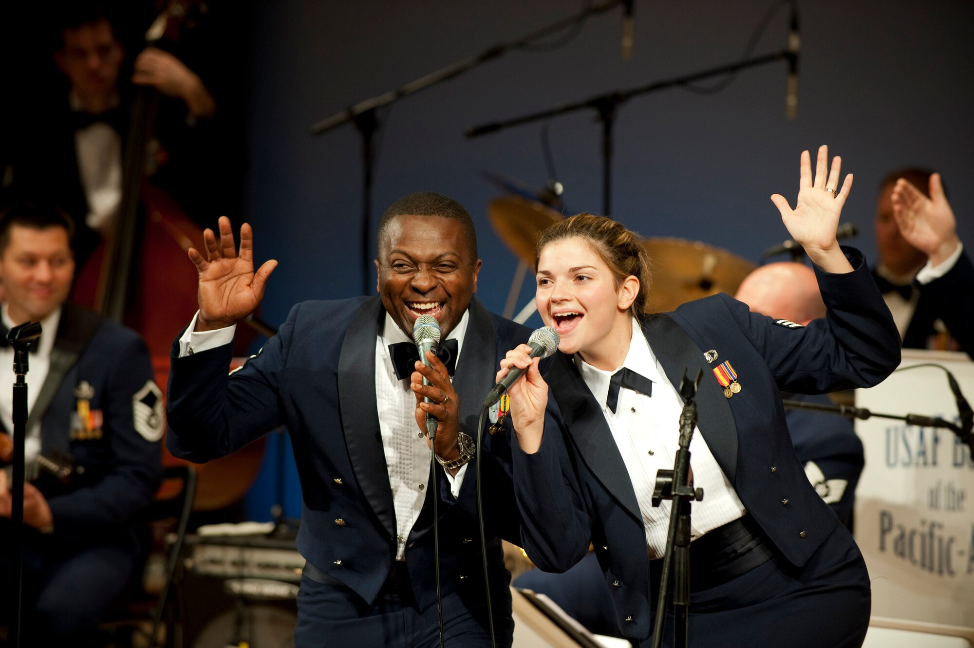 MISAWA AIR BASE, Japan -- The Greatlanders, Pacific Air Forces show band, lead vocalists Master Sgt. John Teamer and Senior Airman Kelly Perry finish the band's final song "What a Wonderful World" at the Misawa International Center Oct. 17. Sergeant Teamer impersonated Louis Armstrong for his performance, receiving both laughter and applause from the audience. (U.S. Air Force photo/Staff Sgt. Samuel Morse)