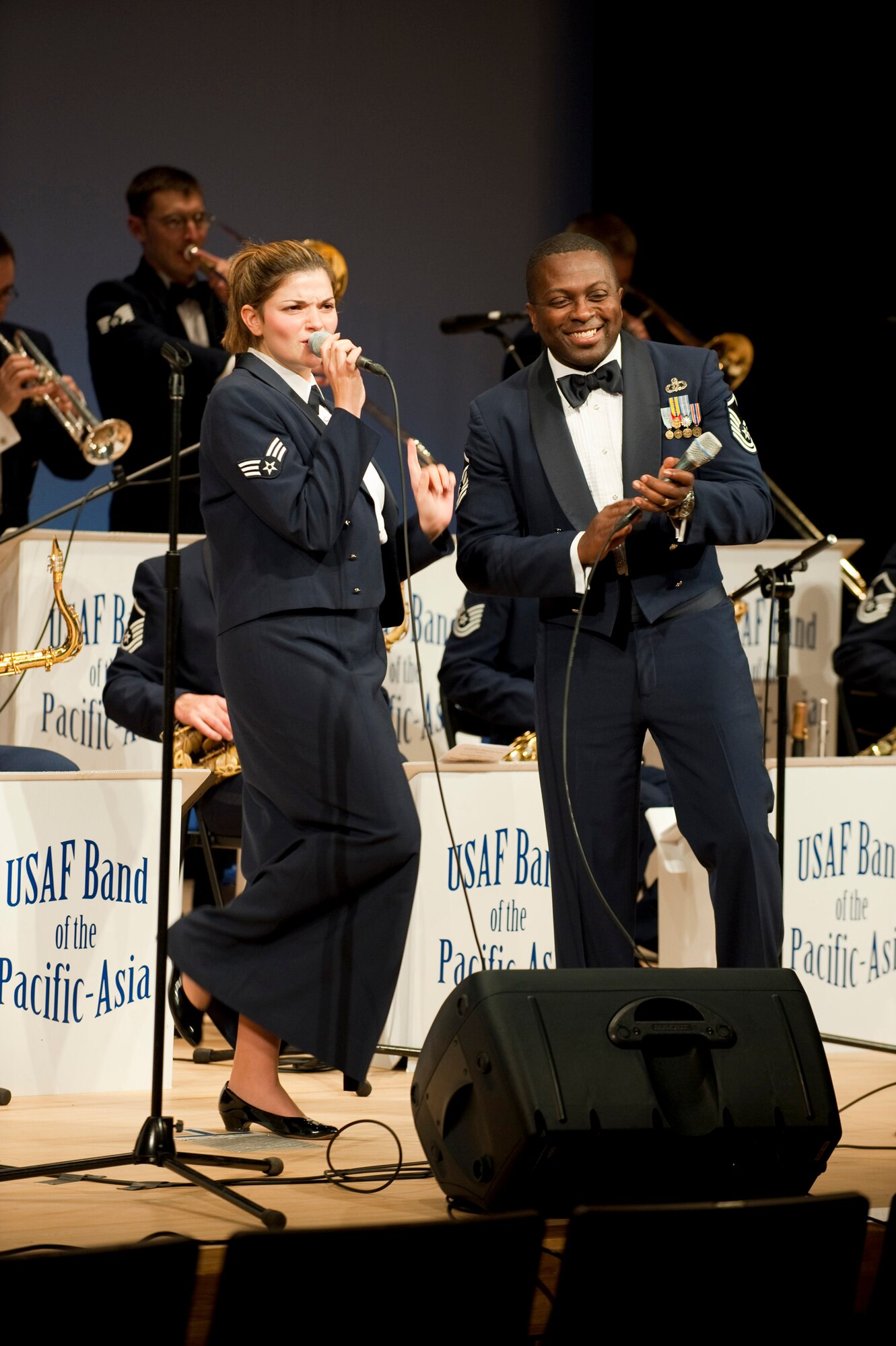 MISAWA AIR BASE, Japan -- Pacific Air Forces show band, Greatlanders, lead vocalists Senior Airman Kelly Perry and Master Sgt. John Teamer sing "Route 66" in the Misawa International Center Oct. 17. The band performed a variety of big band jazz songs, many of which were arranged for the group by their own Master Sgt. George Pierce. (U.S. Air Force photo/Staff Sgt. Samuel Morse)