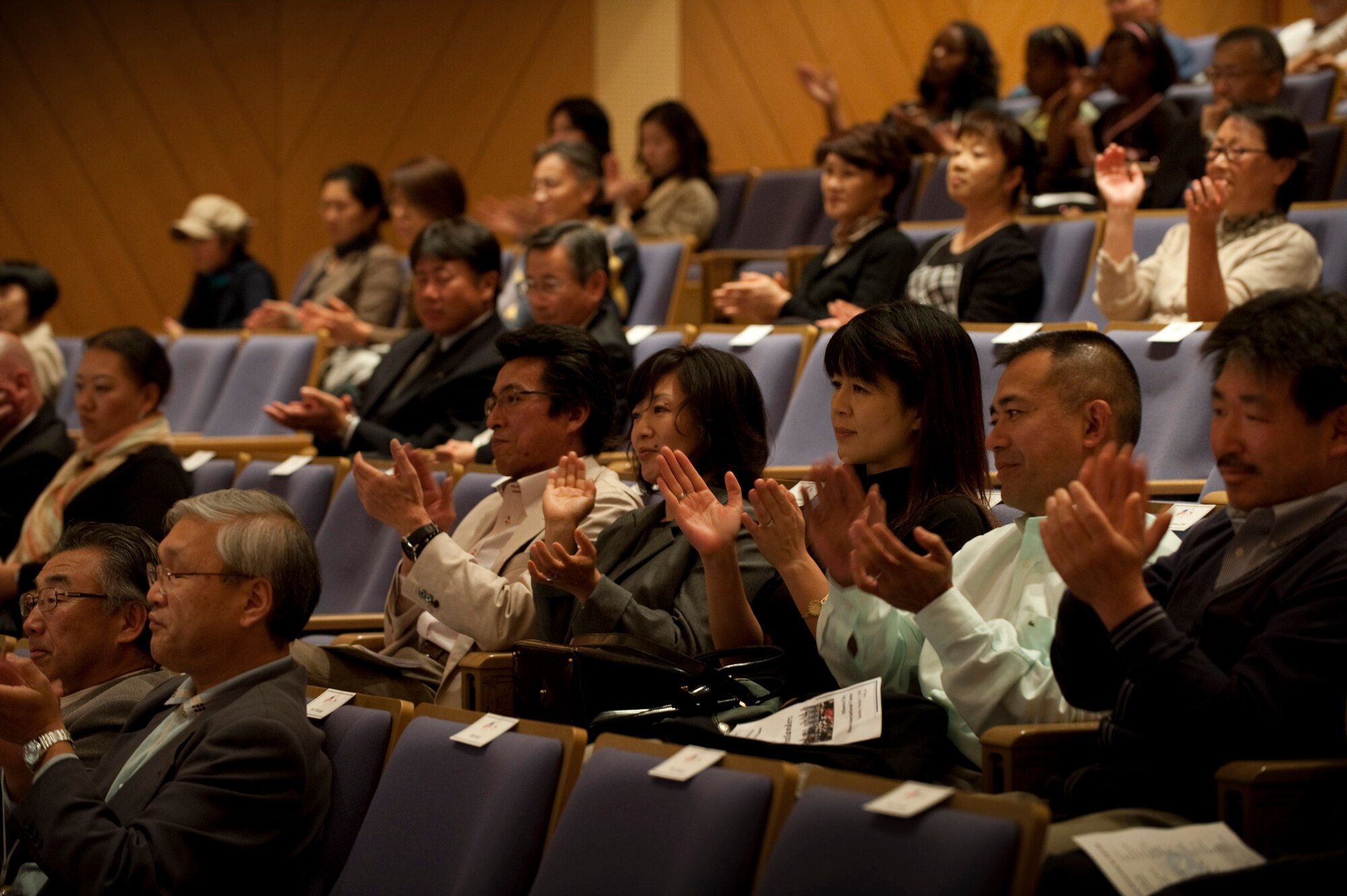 MISAWA AIR BASE, Japan -- Audience members clap with the music played by the Greatlanders, the Pacific Air Forces show band, at the Misawa International Center Oct. 17. The audience consisted of residents from the local community as well as Misawa Air Base. (U.S. Air Force photo/Staff Sgt. Samuel Morse)