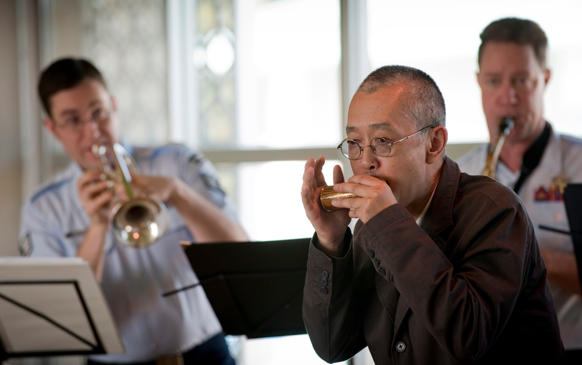 MISAWA AIR BASE, Japan -- Misawa Seishin-kai Hospital director Hirotaka Yahaba plays harmonica with the Greatlanders, the Pacific Air Forces show band, at his hospital Oct. 17. Mr. Yahaba requested the band to play "Sentimental Journey" and was invited up on stage when the band heard him playing along in the audience. (U.S. Air Force photo/Staff Sgt. Samuel Morse)
