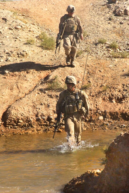 U.S. Marine Corps 2nd Lt. Aiden Katz, front, crosses a stream during a ...