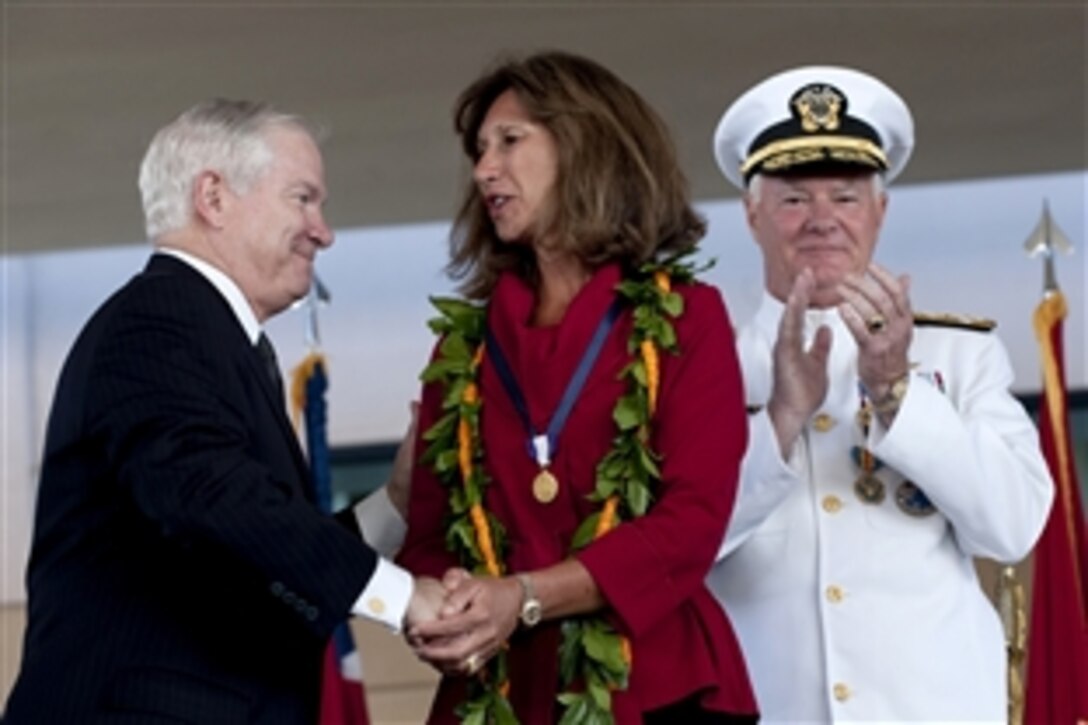 Defense Secretary Robert M. Gates congratulates Wandalee Keating after the presentation of the Distinguished Public Service Award at the U.S. Pacific Command change-of-command ceremony, Camp Smith, Hawaii, Oct. 19, 2009. U.S. Navy Adm. Robert F. Willard relieved U.S. Navy Adm. Timothy J. Keating.