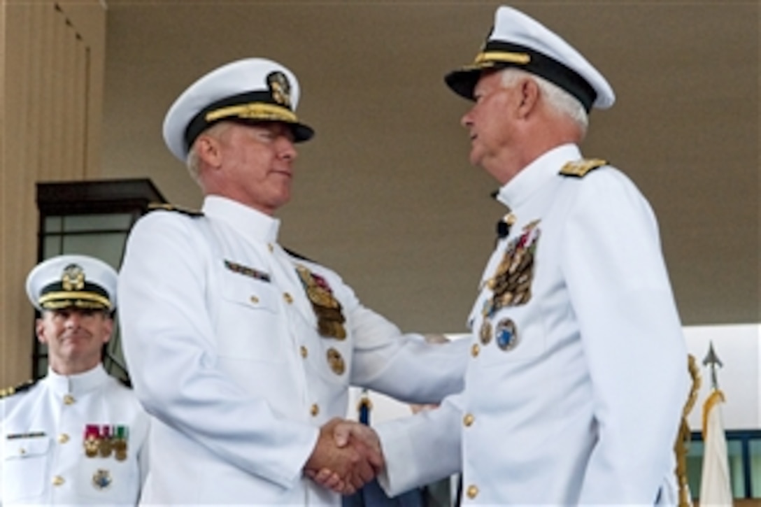 U.S. Navy Adm. Timothy Keating, right,  relinquishes command to U.S. Navy Adm. Robert F. Willard at the U.S. Pacific Command change-of-command ceremony on Camp Smith, Hawaii, Oct. 19, 2009.