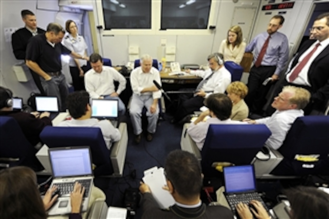 Defense Secretary Robert M. Gates speaks to the press aboard his aircraft, a U.S. Air Force E-4B National Airborne Operations Center, over the Pacific after attending the U.S. Pacific Command change-of-command ceremony on Camp Smith, Hawaii, Oct. 19, 2009. 