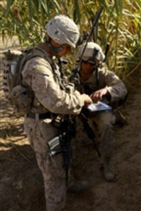 U.S. Marine Corps Sgt. Joseph Giardino and 1st Lt. Jason Loucks, both with Bravo Company, 1st Battalion, 5th Marine Regiment, go over their patrol route during a security patrol through the Nawa district of Helmand province, Afghanistan, on Oct. 14, 2009.  Marines conduct security patrols to decrease insurgent activity and gain the trust of local people.  The Marines are deployed with Regimental Combat Team 3 to conduct counterinsurgency operations with Afghan National Security Forces in southern Afghanistan.  