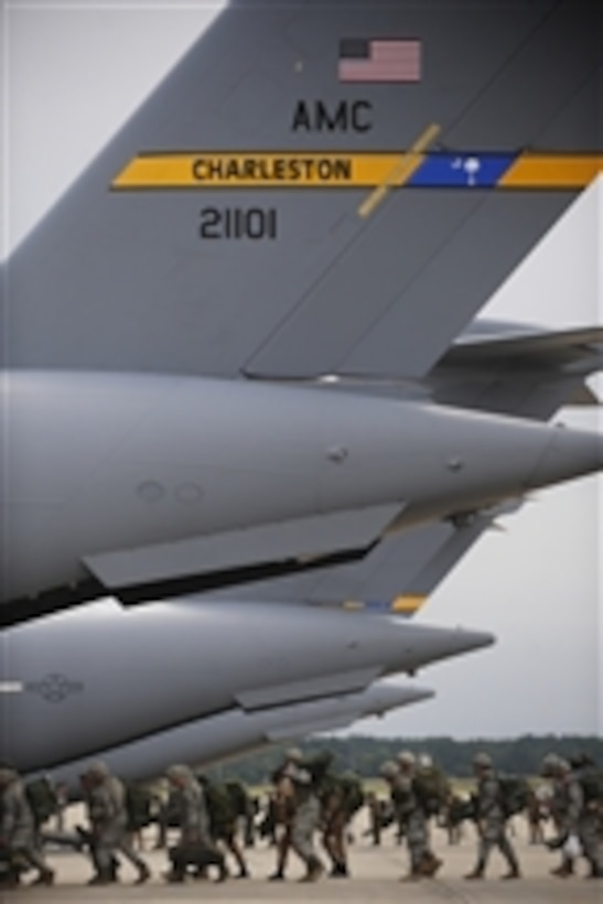 U.S. Army and international paratroopers load onto a U.S. Air Force C-17 Globemaster III aircraft at Pope Air Force Base, N.C., en route to Egypt during Exercise Bright Star on Oct. 11, 2009.  Bright Star is, among other things, a joint international military airdrop exercise.  This year's participants include the United States, Egypt, Kuwait, Pakistan, Germany and Jordan.  