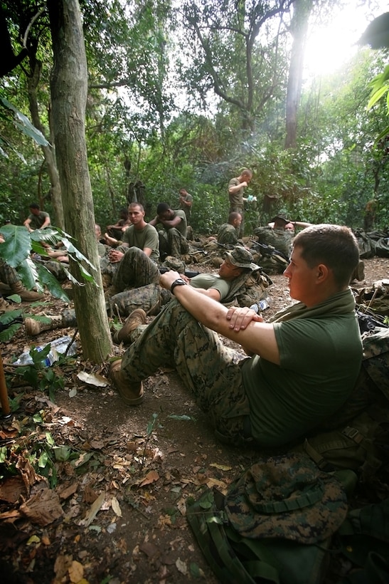 Marines with Battalion Landing Team 2/4, 11th Marine Expeditionary Unit, relax before taking part in jungle survival training with Indonesian Marines here Oct. 21. Indonesian Marines taught members of the MEU how to navigate the jungle, set booby traps, and capture and cook animals for food during an exercise there Oct. 17-23.